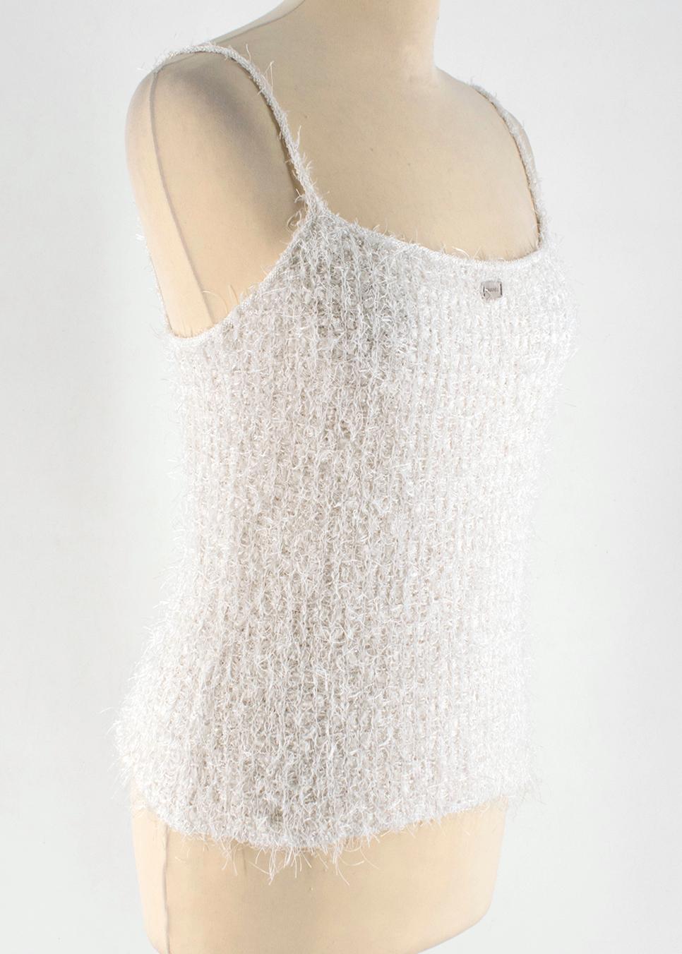 Chanel White Tweed Cami Top

White tweed tank top
Thin straps
Round neck 
Silver hardware
Silver Chanel on front of the top 

Please note, these items are pre-owned and may show some signs of storage, even when unworn and unused. This is reflected