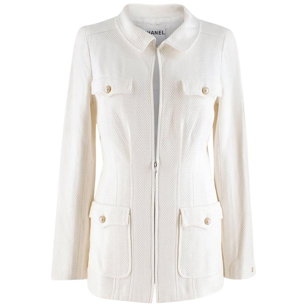 Chanel White Tweed Jacket

- White, mid-weight tweed jacket
- Padded shoulders, long sleeves 
- Breast pockets
- Front flapped pockets
- Faux-pearl embellished buttons
- Round neck, hook-and-eye fastening
- Gold-tone metal hardware, logo embroidery