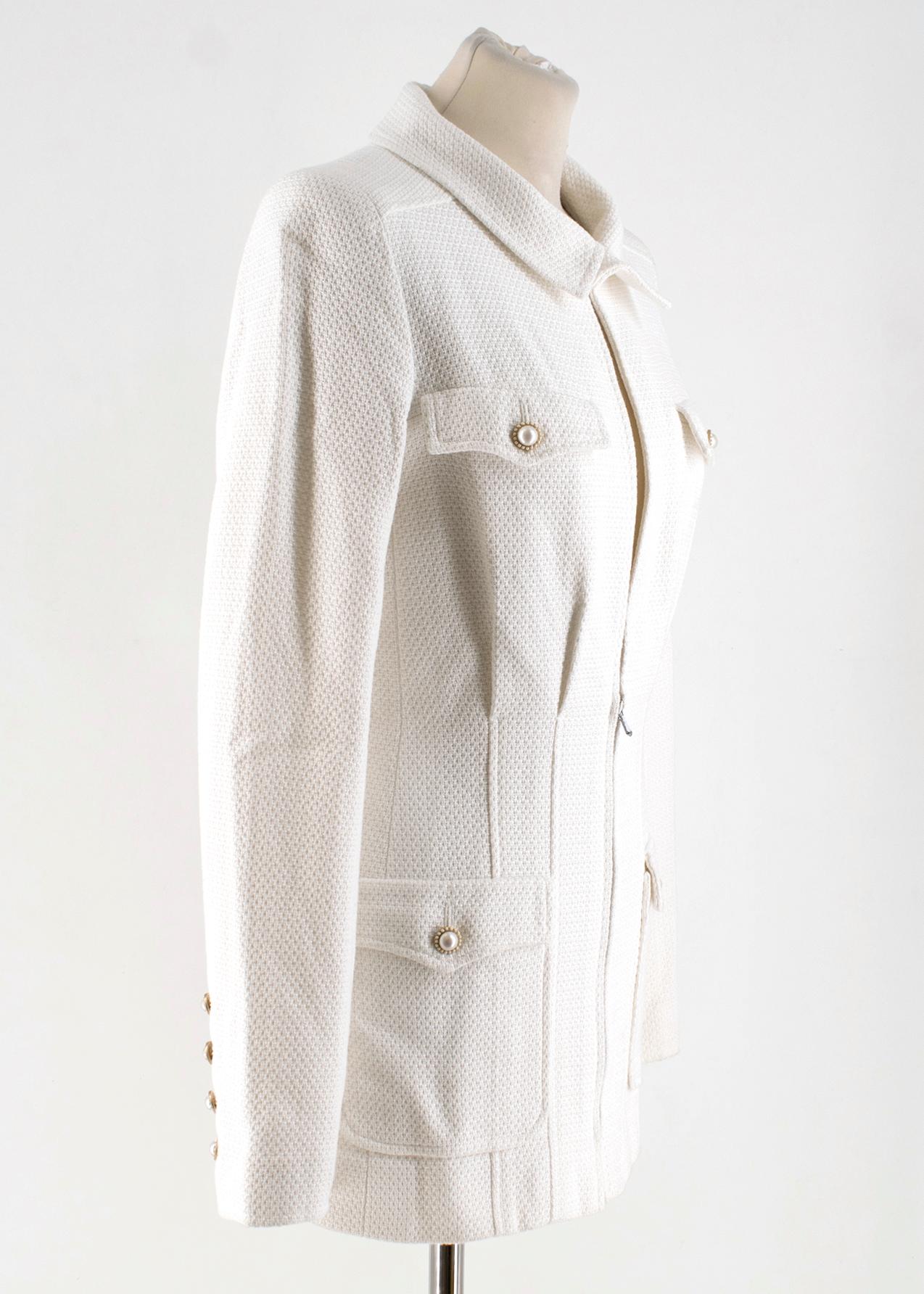 Chanel White Tweed Jacket

- White, mid-weight tweed jacket
- Padded shoulders, long sleeves 
- Breast pockets
- Front flapped pockets
- Faux-pearl embellished buttons
- Round neck, hook-and-eye fastening
- Gold-tone metal hardware, logo embroidery
