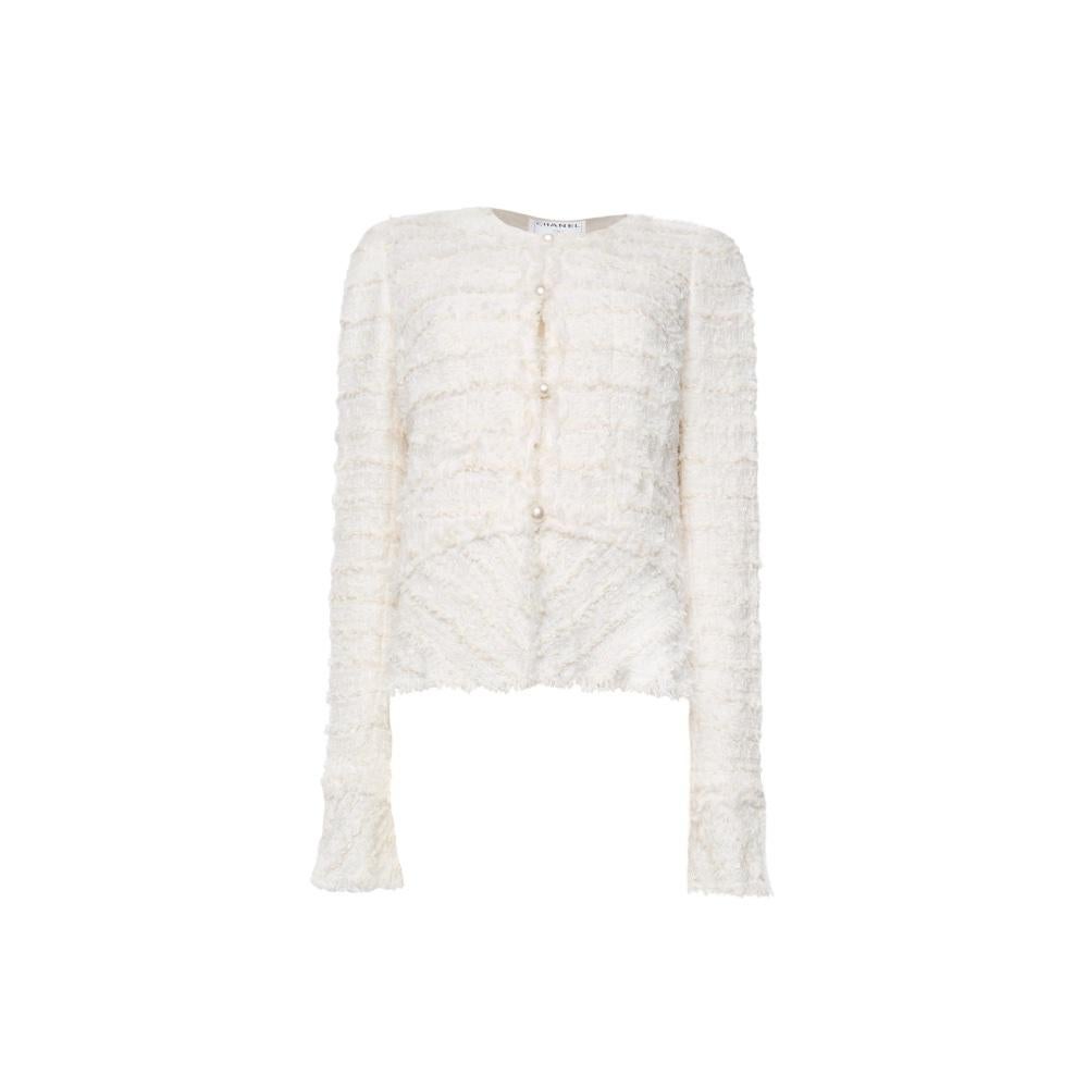 This exquisite Chanel white tweed jacket from the Spring 2005 collection is a timeless piece designed by the iconic Karl Lagerfeld. Known for its refined elegance and impeccable craftsmanship, this jacket features the brand's signature tweed fabric,