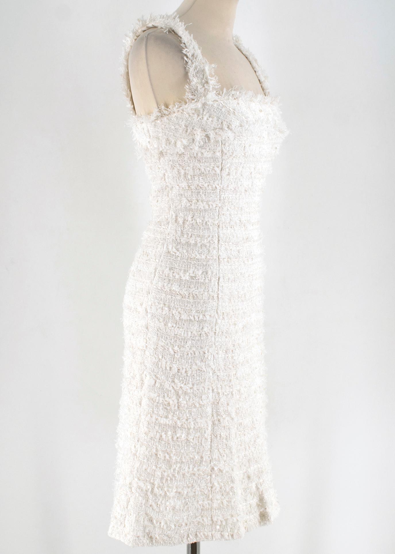 Chanel White Tweed Sleeveless Dress 

White tweed dress, with shoulder straps,
Hidden rear zip fastening with two iconic CC button closures,
Soft silk interior lining,
Features white embellishment detailing,
Mid-weight 

Please note, these items are