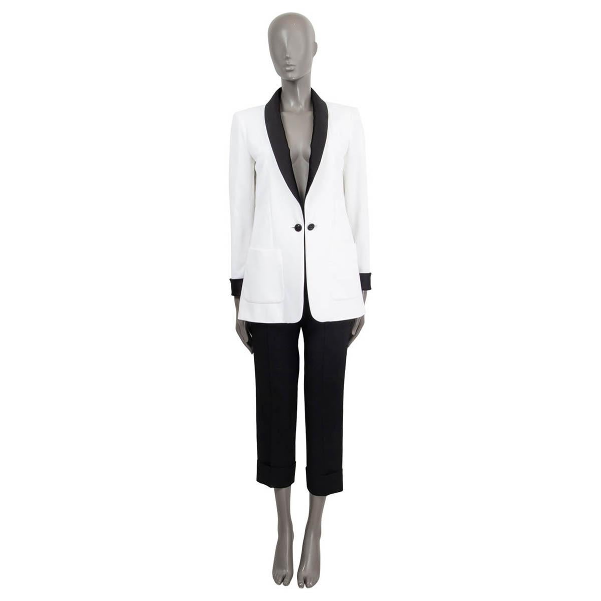 100% authentic Chanel 2018 crepe tuxedo jacket in white viscose (100%) with a satin collar and cuffs in black polyester (70%) and silk (30%). Features two patch pockets on the front. Opens with one 'CC' button on the front. Lined in off-white silk
