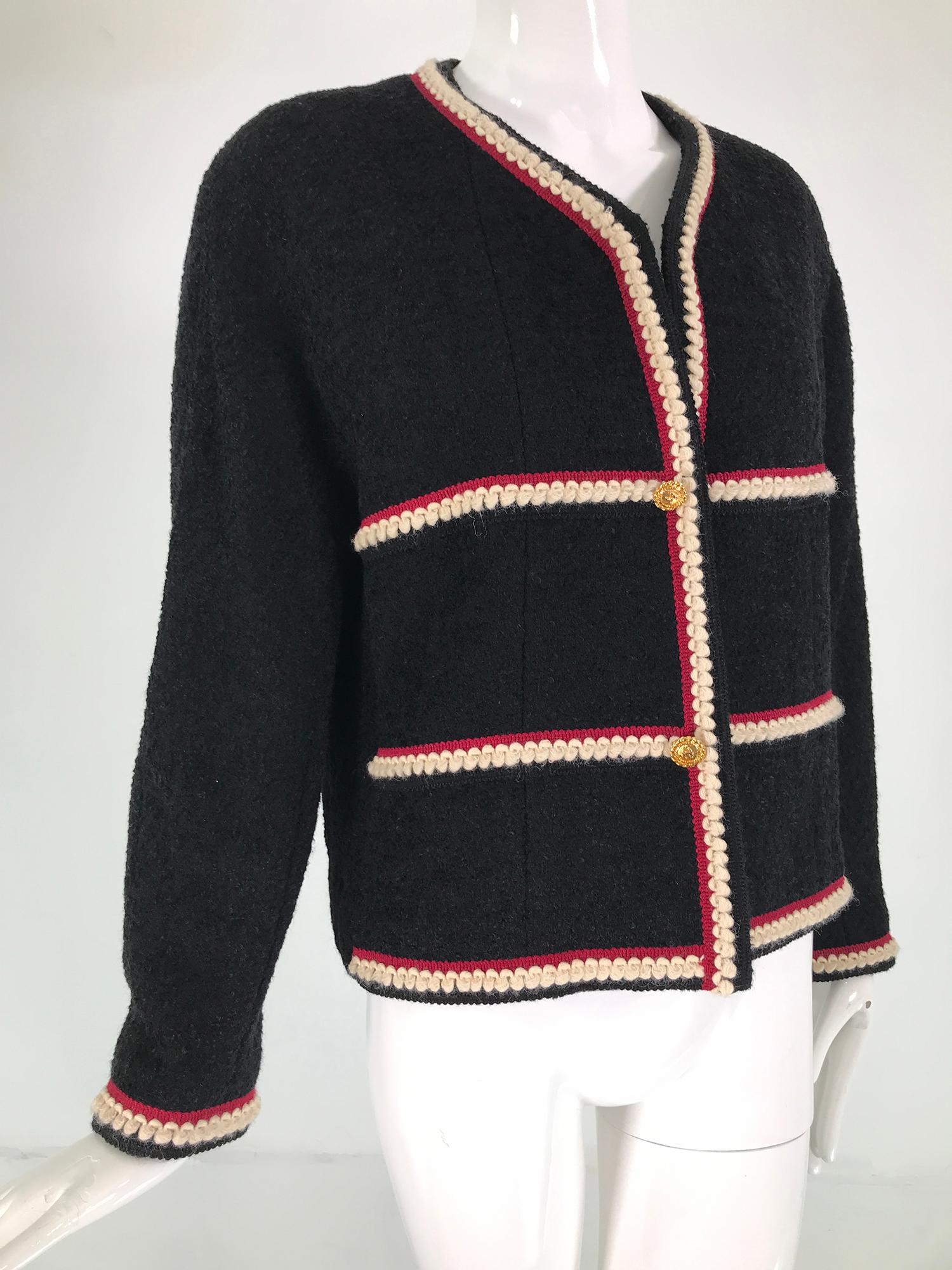Chanel white angora & wine braid trim, black boucle jacket from the 1990s. The trim, a row of wine braid & below, loop braid of white angora. The jacket has 2 non working gold Chanel buttons at the front with hidden hook & eyes behind, there are 
