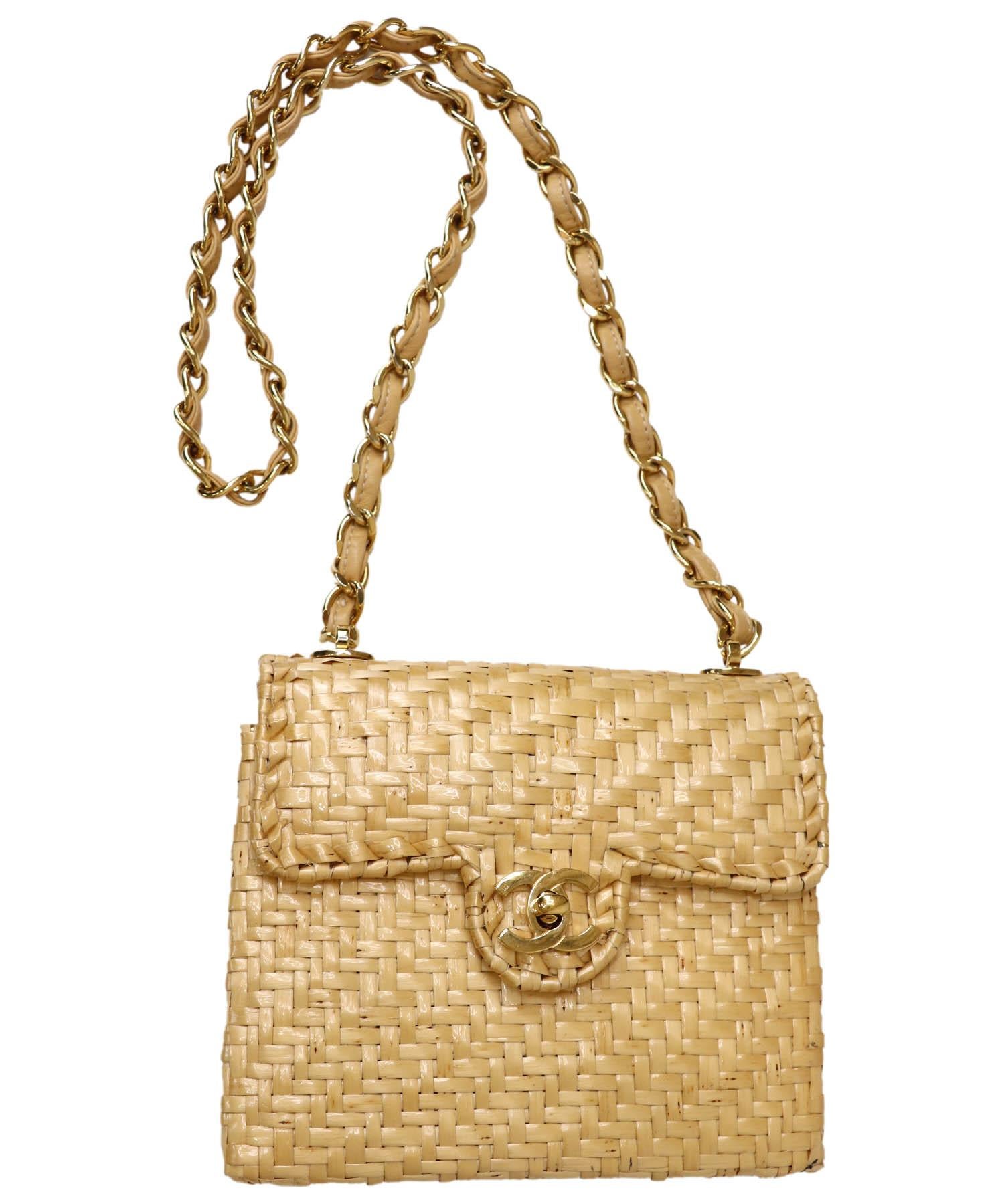 What a fabulous find! This rare vintage tan Chanel wicker shoulder or short crossbody bag is small and square in shape and has a 24k gold plated CC Turnlock closure at the front. The bag and flap are both structured. Flap opens to a hinged interior