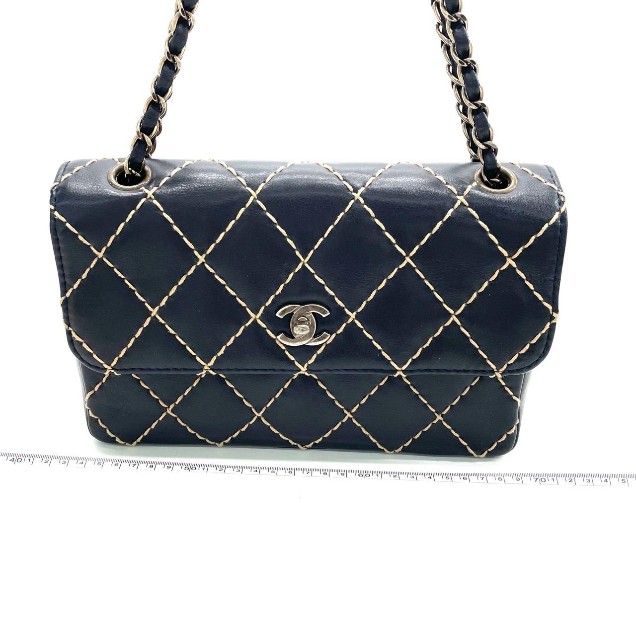 Accent your wardrobe with this timeless vintage Chanel Classic Flap handbag, crafted from a durable beige leather and modernized with a beige stitching detail. The antiqued gold hardware and cowhide leather construction gives you the assurance of a