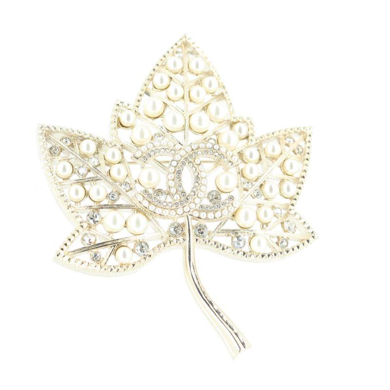 Chanel Winter collection ready to wear brooch

Excellent condition, shows almost no signs of use nor wear.
White pearls, strass and white gold tone hardware metal, implemanted with a cc logo on the center
No chanel signature stamp
Packaging: 