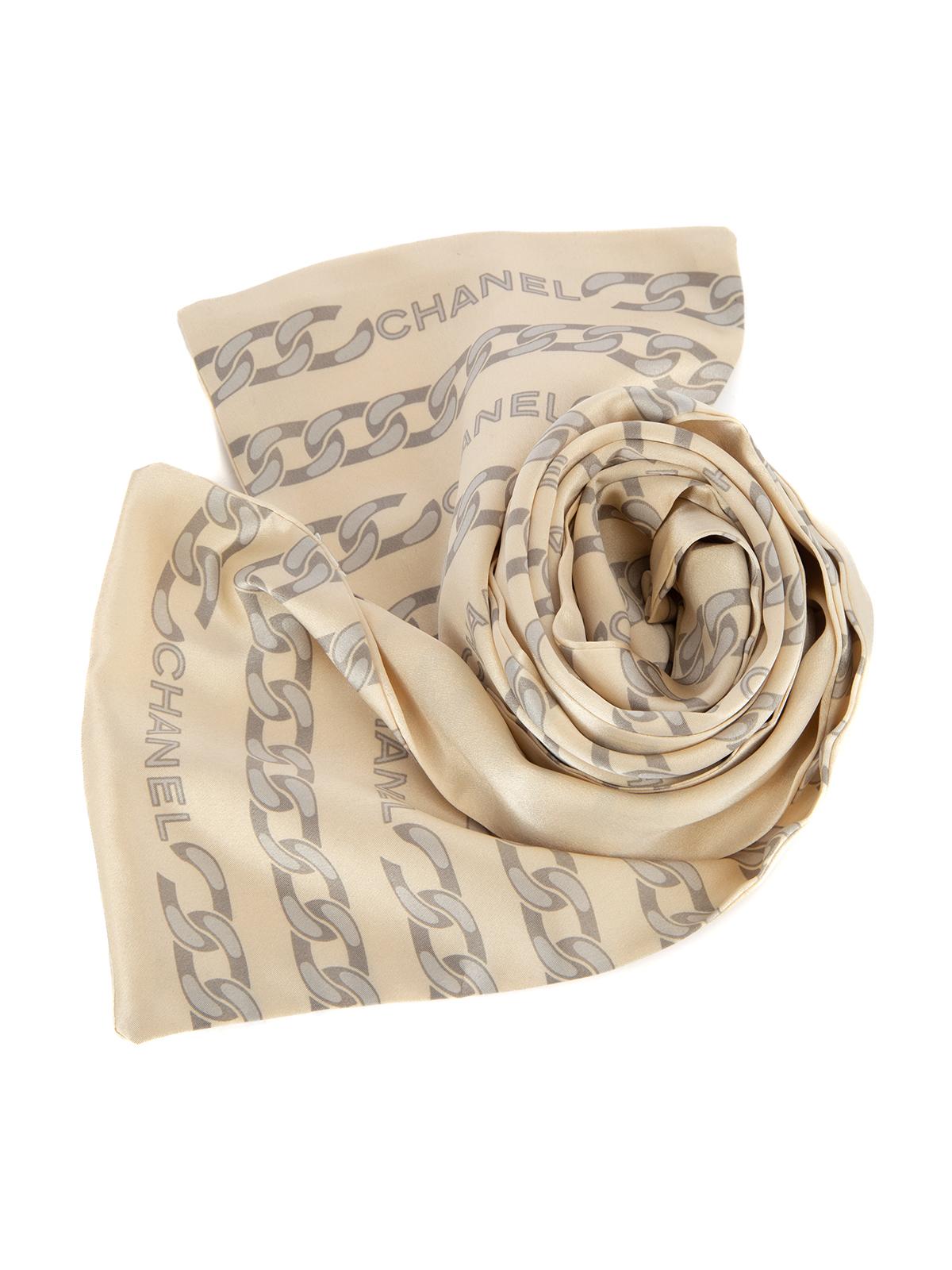CONDITION is Very good. Minimal wear to scarf is evident. There is a very tiny stain on this used Chanel designer resale item.   Details  Cream Silk Scarf Grey chains pattern with Chanel logo   Made in Italy   Composition 100% Silk Care