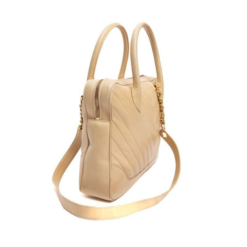 Editor's Note Tote around this chic used Chanel top handle bag to make the ultimate style statement. Easy to carry by hand or wear on the crook of your arm, this vintage beige chevron pre-loved Chanel top handle bag is set to make a welcomed