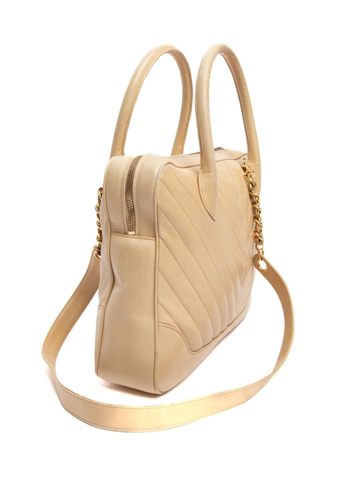 Editor's Note

Tote around this chic used Chanel top handle bag to make the ultimate style statement. Easy to carry by hand or wear on the crook of your arm, this vintage beige chevron pre-loved Chanel top handle bag is set to make a welcomed