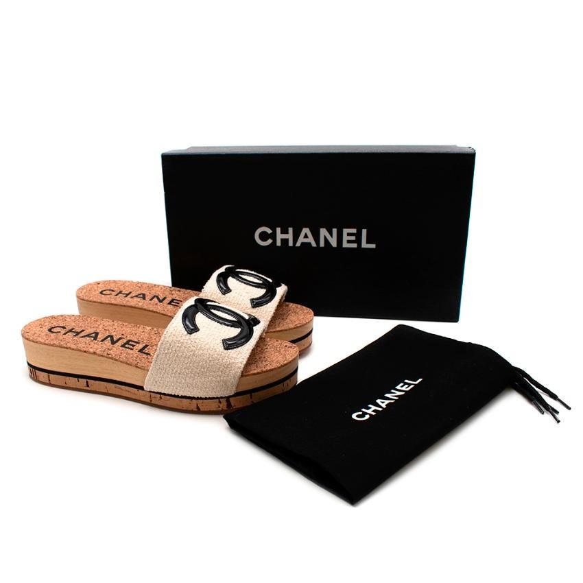 Chanel Wood and Cork Beige Logo Platform Slides 

-Patent leather Chanel logo 
-Soft textured beige strap 
-Luxurious wood and cork platform with a contrasting black line
-Soft swede strap lining
-Rubber coated soles for safety 
-Original box and