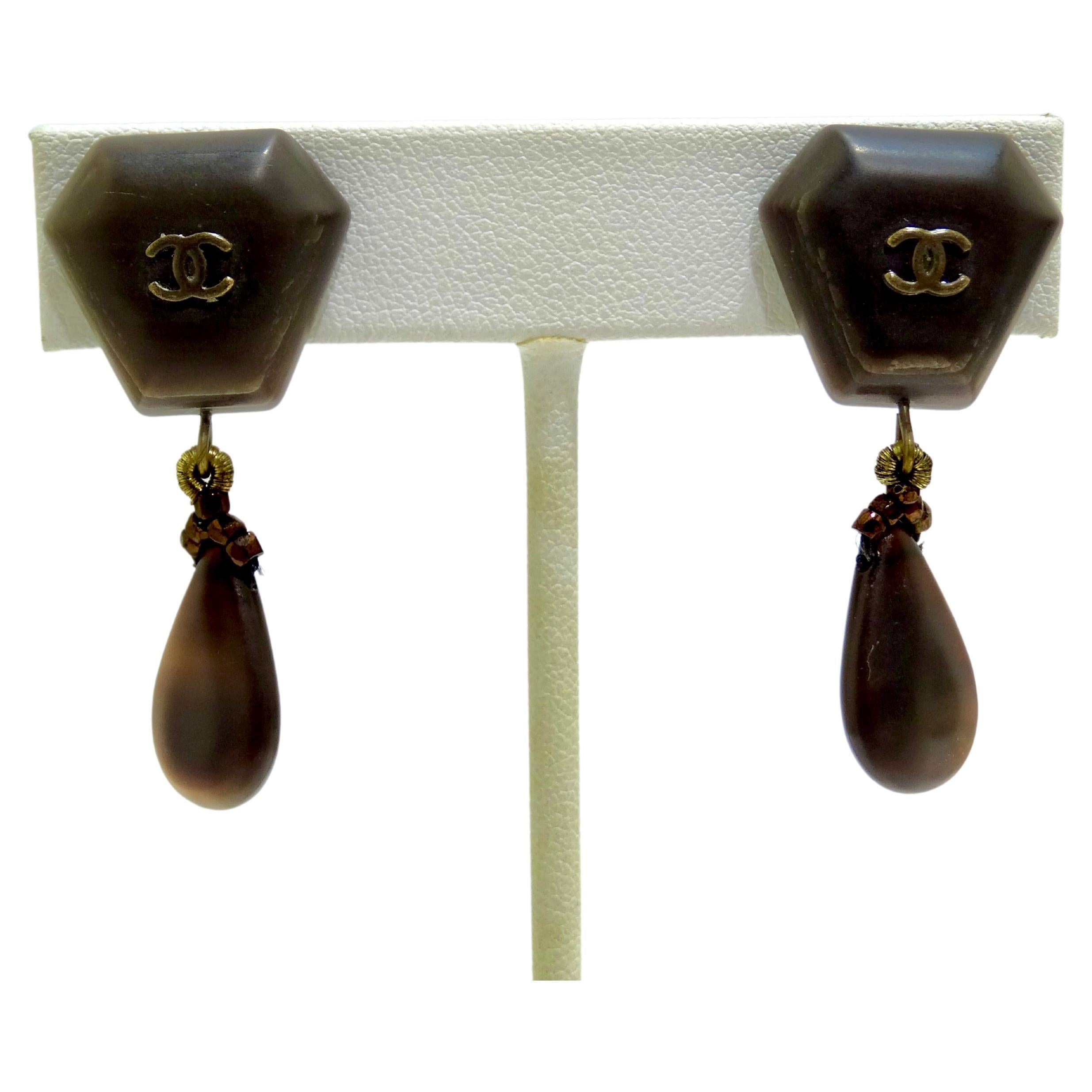 Chanel brings elegance and simplicity to the table with these 1999 Autumn Collection 'CC' drop earrings. An iconic emblem for the brand, Chanel's Interlocking CC motif has been a key cornerstone in collections for years. Boasting a wood