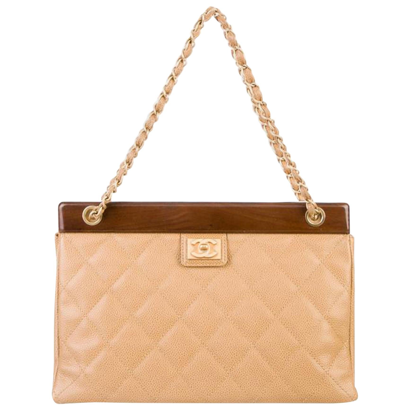 Chanel Vintage Classic Beige Caviar Wood Medium Tote Bag

Gold hardware
CC logo at front
Beige quilted Caviar leather
Classic interwoven chain straps
concealed magnetic closure at top frame
Leather lined beige interior
Main interior zippered