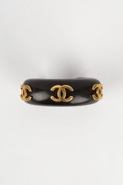 Chanel Wooden Bracelet Decorated with Gilded Metal CC Logos