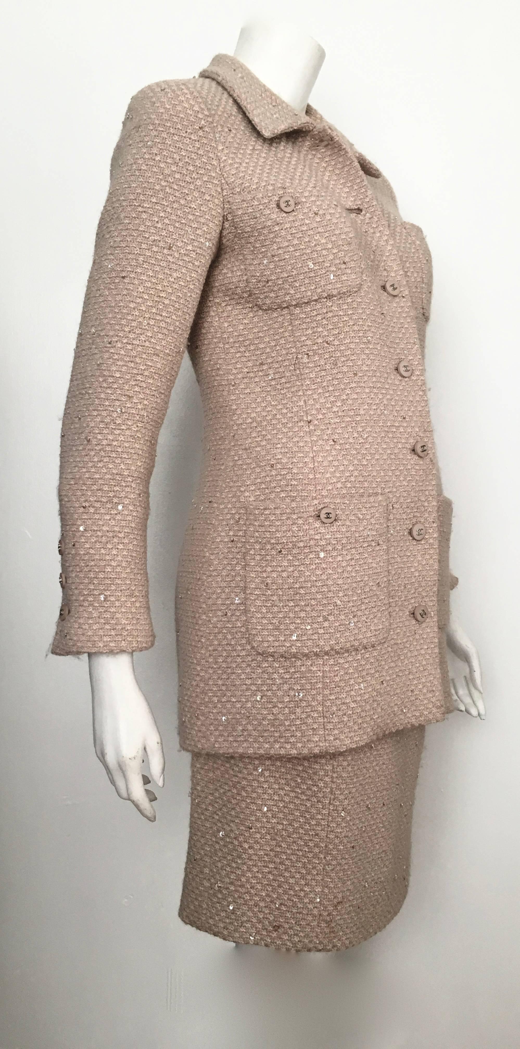 Chanel 1990s beige wool sequin jacket & skirt suit is a French size 36 and fits a size 4. There are seven logo buttons on the jacket and three on the backside of skirt. Of course both pieces are fully lined.  There are no pockets on the skirt so you
