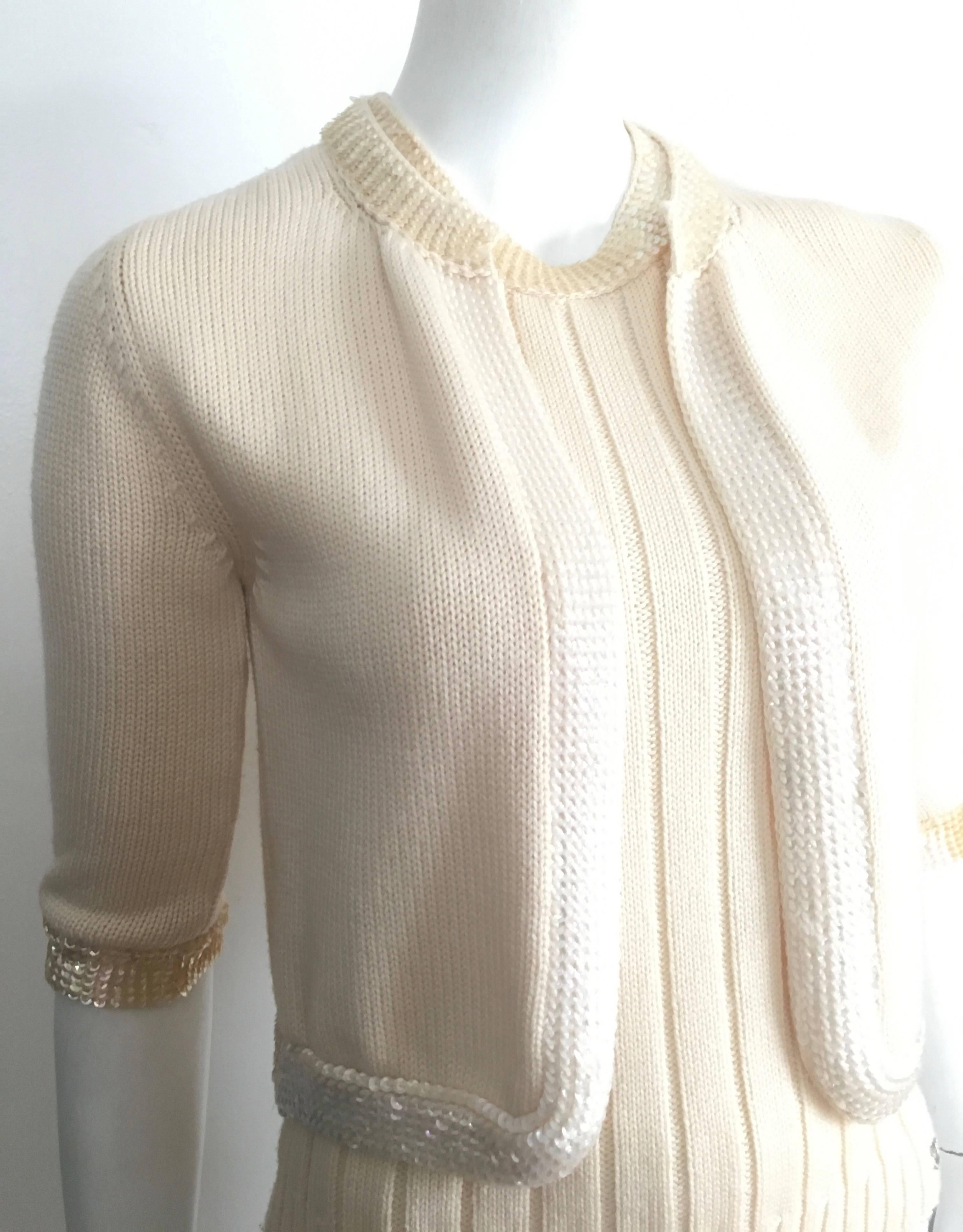 Chanel wool cream knit sequin trimmed tank & matching cardigan set is a French size 38 and fits a size 4.  Ladies if you are looking for that classic Chanel top today is your lucky day. This timeless tank & cardigan set is just perfection but when