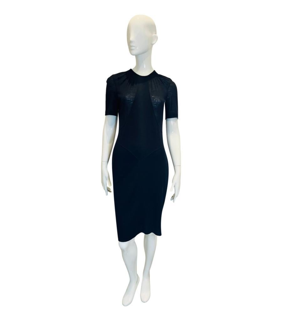 Chanel Wool Dress

Black fitted dress designed with round gathered neckline and short sleeves.

Detailed with black 'CC' logo button closure to rear and knee-length.

From Fall 2009 Ready-To-Wear Collection.

Size – 38FR

Condition – Very