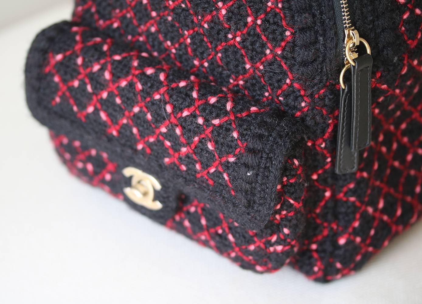 Chanel wool woven tweed backpack. Black and pink woven thread detail. Chanel Tweed Twist backpack with antiqued gold-tone hardware, black lambskin leather zip, leather straps, dual adjustable leather shoulder straps, single interior pocket, zip main