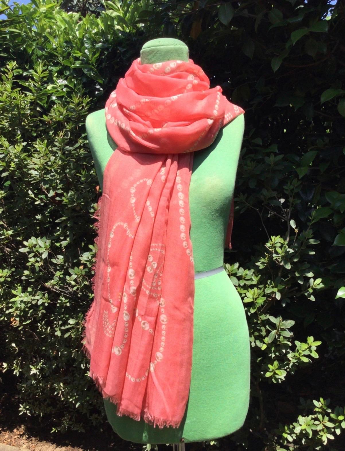 Salmon pink Chanel stole featuring pearl necklaces design. The stole is a mix of wool, silk and cashmere. Length 183 cm, width 130 cm. With original envelope. Perfect condition.