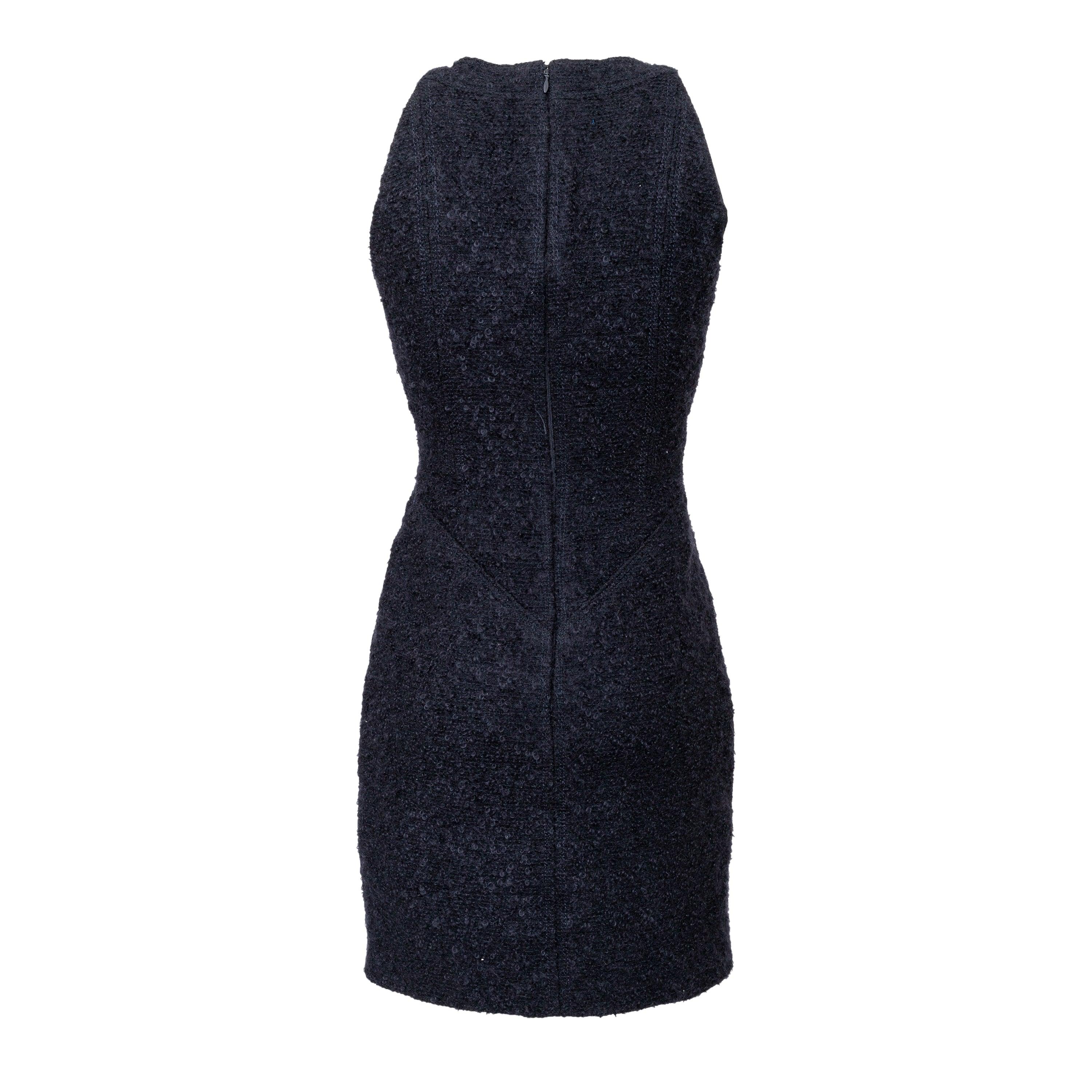 A-line midi dress in navy blue wool with embossed weave featuring interlocking CC logo, sleeveless scoop neck, and concealed zip and silk lining.
 Remarks: the size tag is cut off. 
 Measurement: Shoulder:23;Bust:36;Waist:29;Length:84 
 Material: