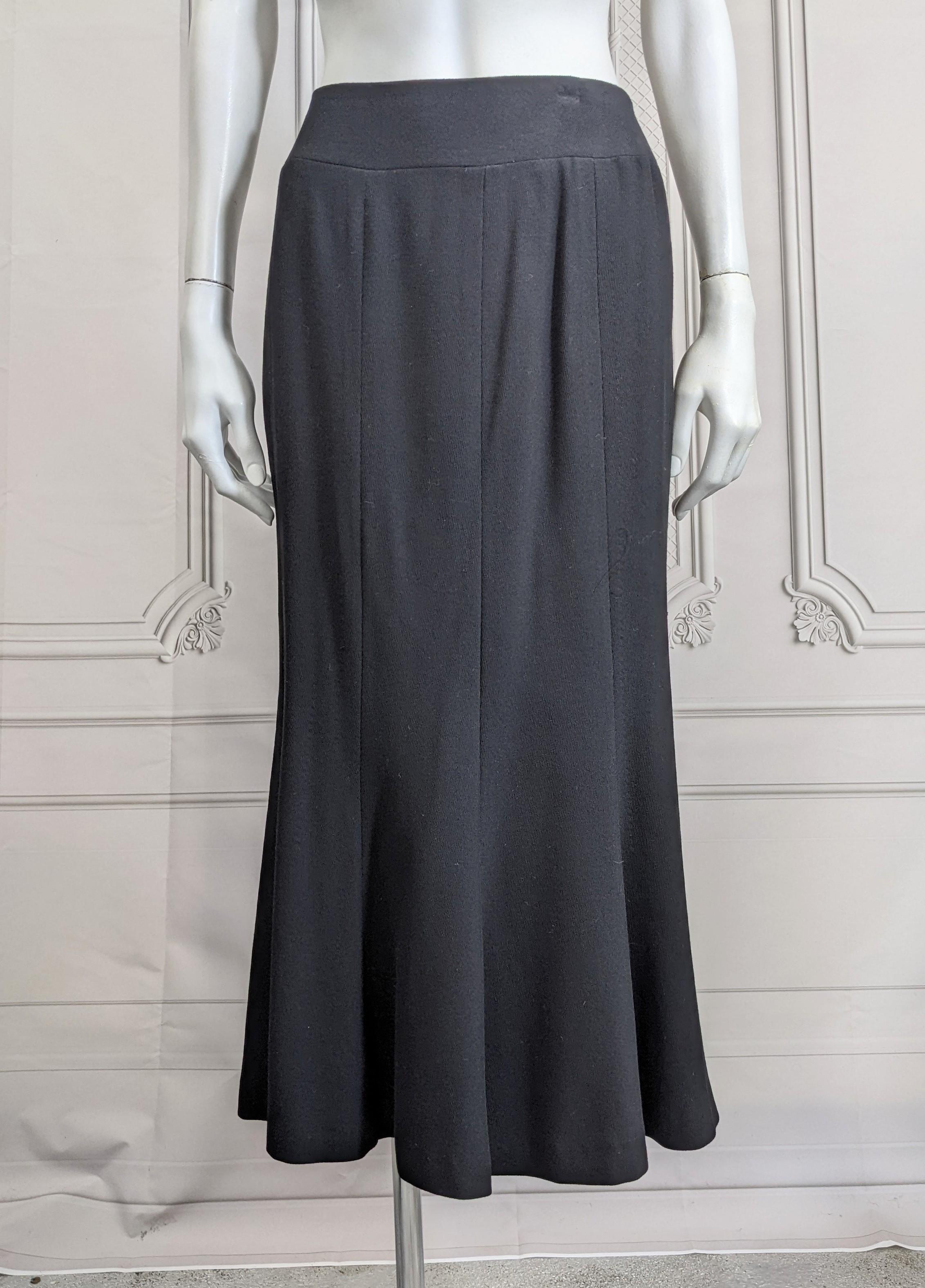 Chanel Soft Deep Black Wool Twill Fit and Flare Trumpet Skirt from the 1990's. Pieced with a hip yoke and 3 panel front and back which release to fullness at knee. Back zip with silk lining. Size 38 Vintage, 1990's France. 
Waist 26