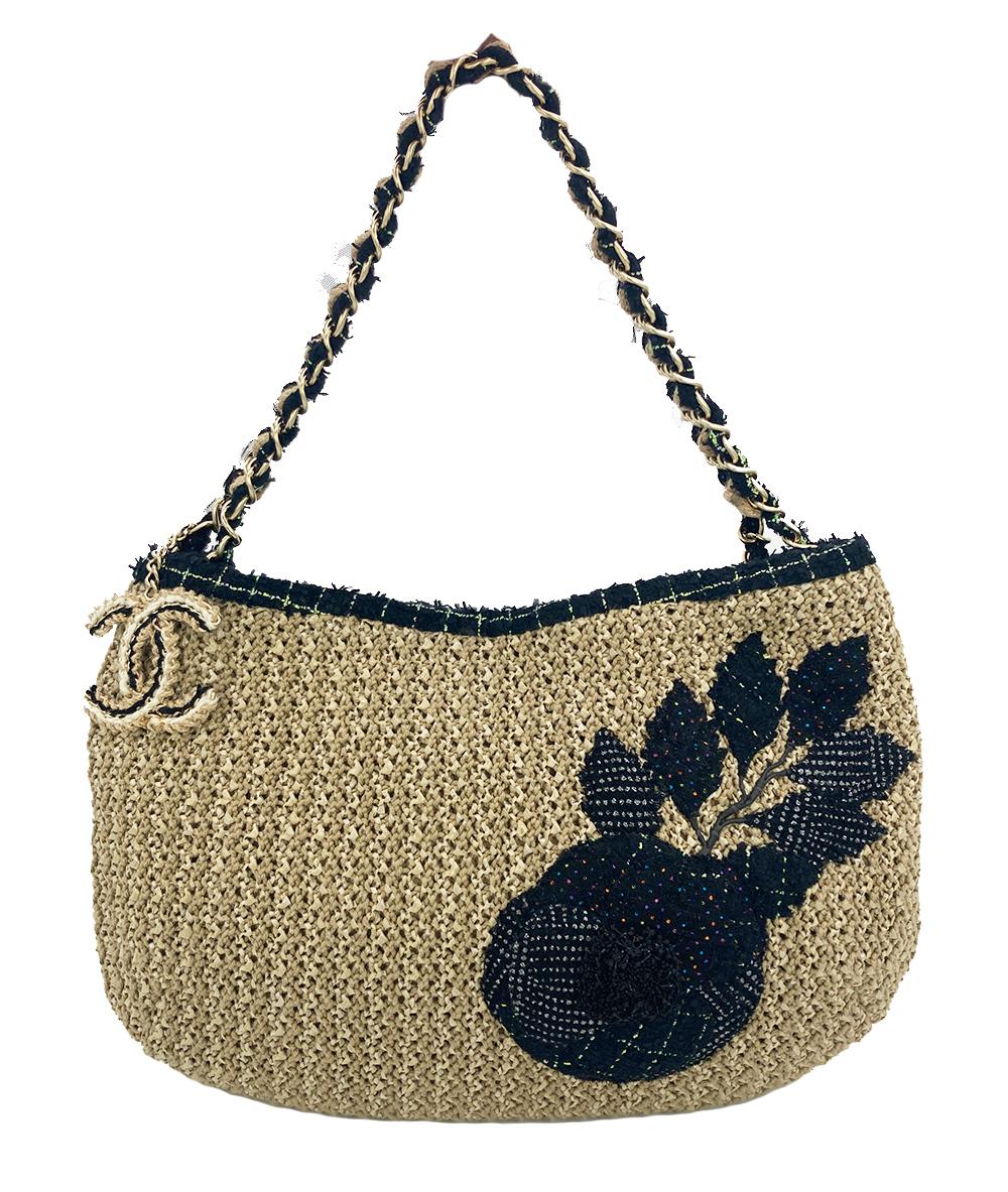 Chanel Woven Tan Rattan Straw Wool Trim Camellia Flower Shoulder Bag in excellent condition. Woven, crocheted tan straw rattan with black printed wool tweed boucle camellia flower along front side and matte gold hardware. Woven wool, straw and