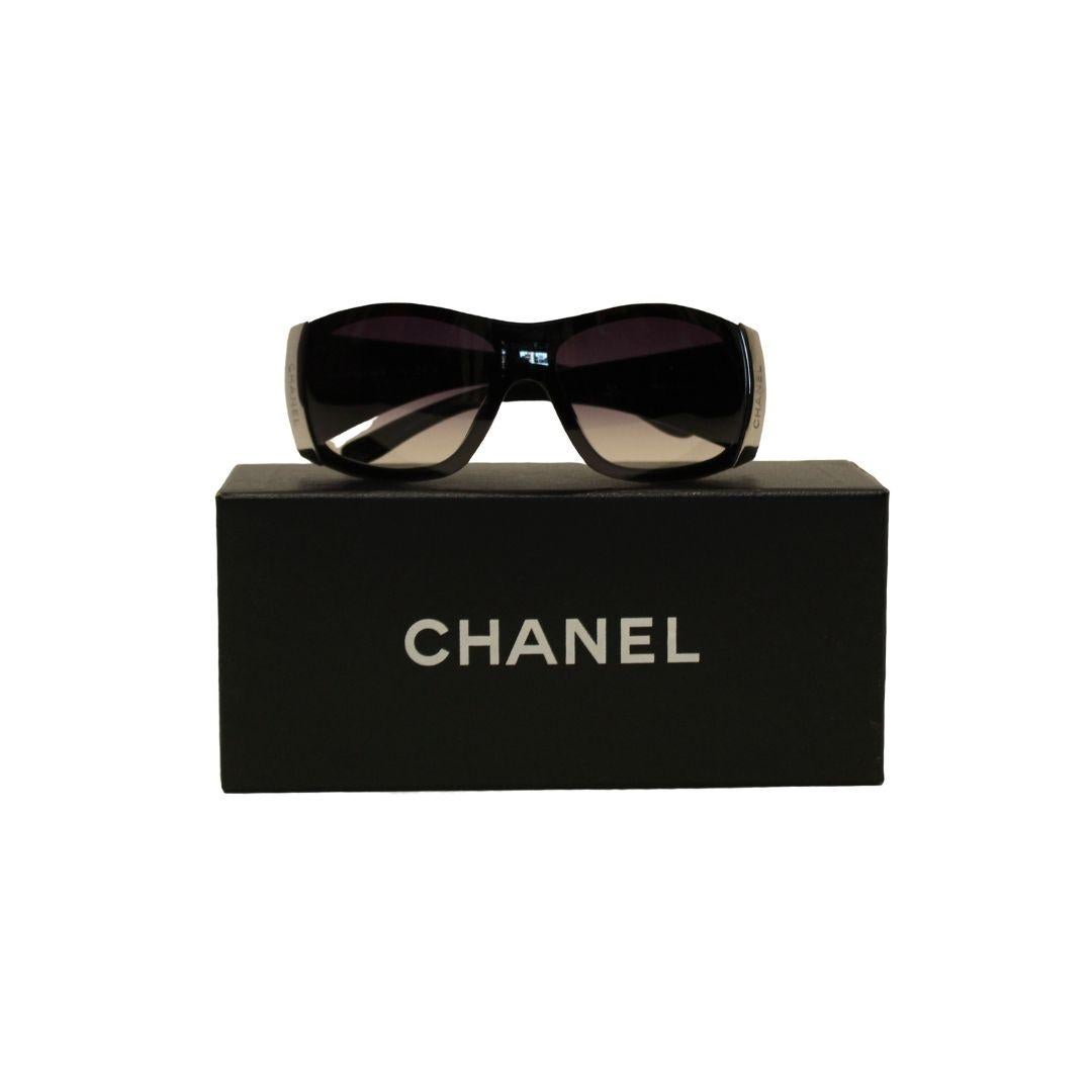 CHANEL wrap style sunglasses with dark brown gradient lens and quilted arms.