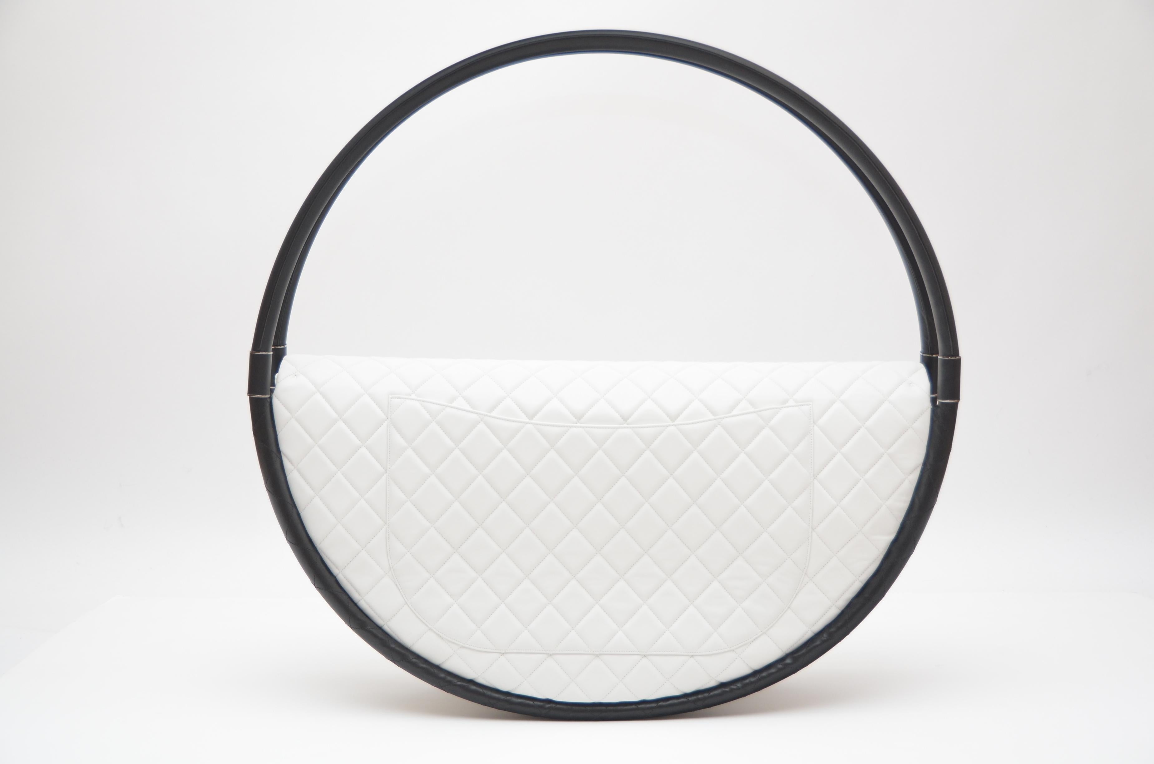 

Chanel Hula Hoop  X Large size bag. Collector's  or decor piece  .
When this bag hit the runways in 2013 it was most talked about  that season.It was 

Quilted  pure white color  lambskin leather with 2 black hula circles covered with fine