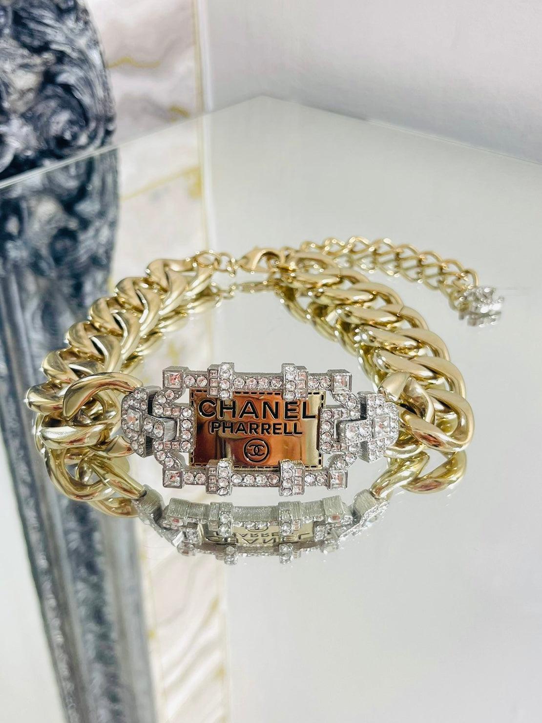 Chanel x Pharell Williams Chunky Chain & Crystal Choker Necklace

Rare oversized gold link necklace with an engraved plaque 

'Chanel, Pharell, CC' that is surrounded by crystals. Long dangle

lobster closure with a 'CC' logo in crystals. From 2019
