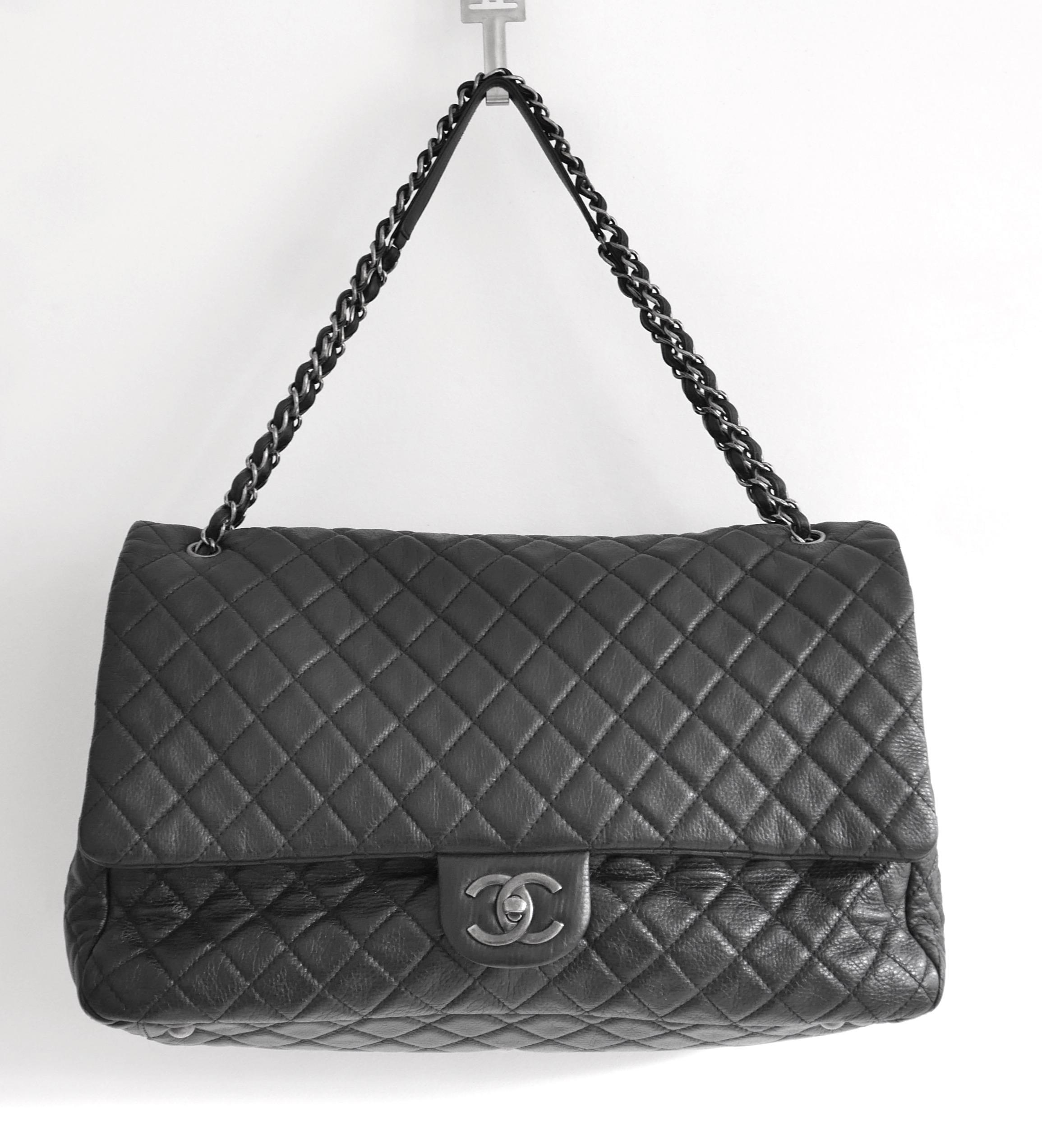 Fabulous Chanel XXL Travel Flap Bag. Used once and comes with authenticity card. Crafted from black caviar leather with antiqued silver hardware, it has CC turnlock closure, adjustable chain and leather strap, domed feet and back pocket. Lined with