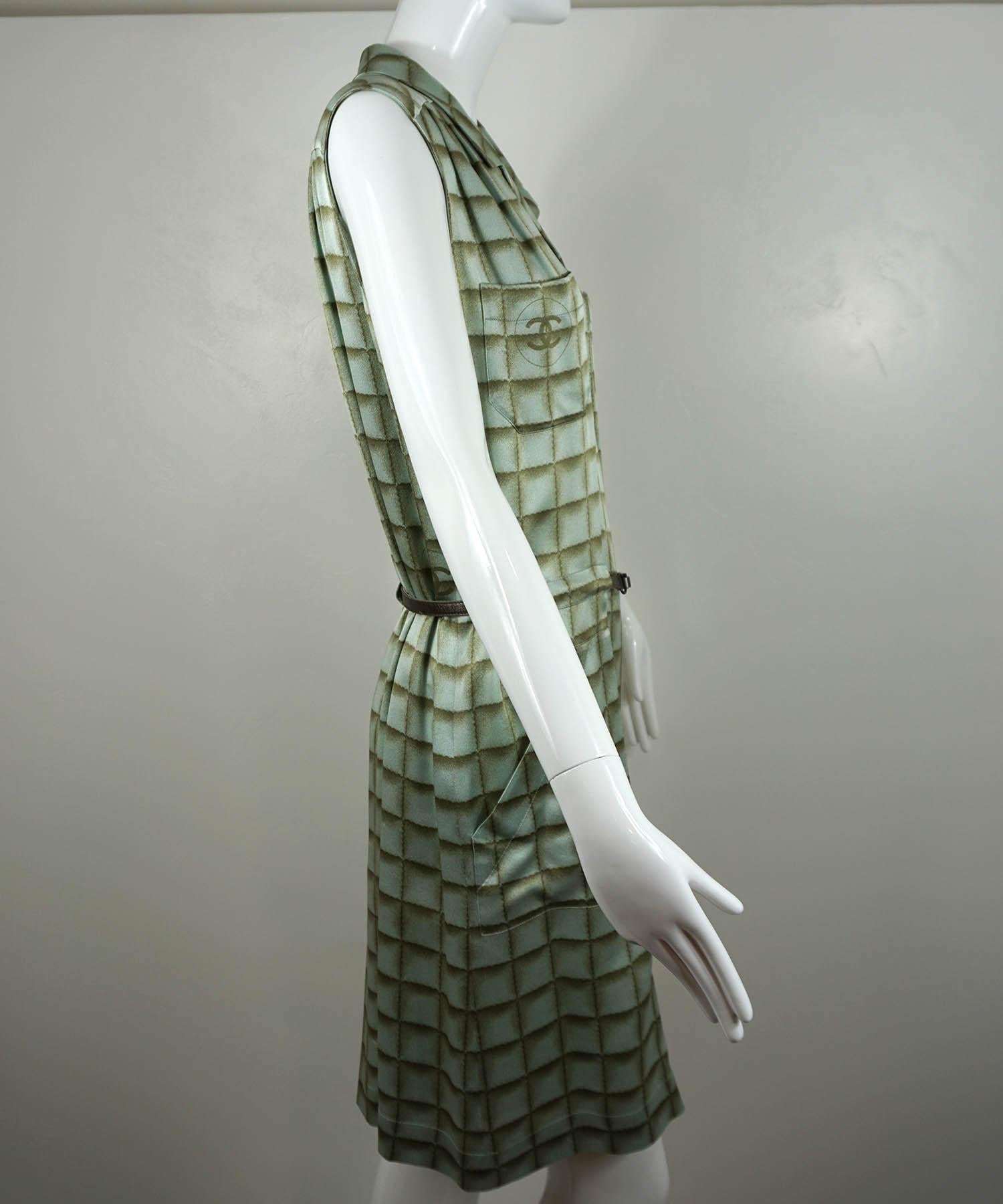 Chanel sleeveless dress, from their 2000 Fall Collection, is featured in seafoam green silk with a built in metallic brown belt, four pockets and interlocking CC logo details. Designer size 42. Made in France. Very good condition: minor snags to