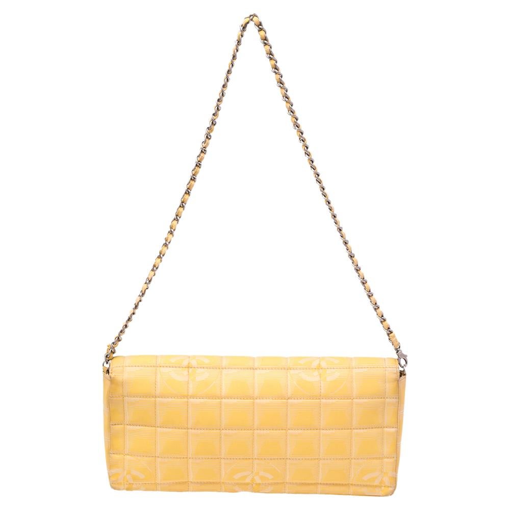 This beautifully fashioned bag will surely be a favorite in your closet. Crafted in a quilted style using yellow fabric, this East West Flap bag is equipped with a woven chain link and a well-sized interior. You are sure to love this timeless Flap