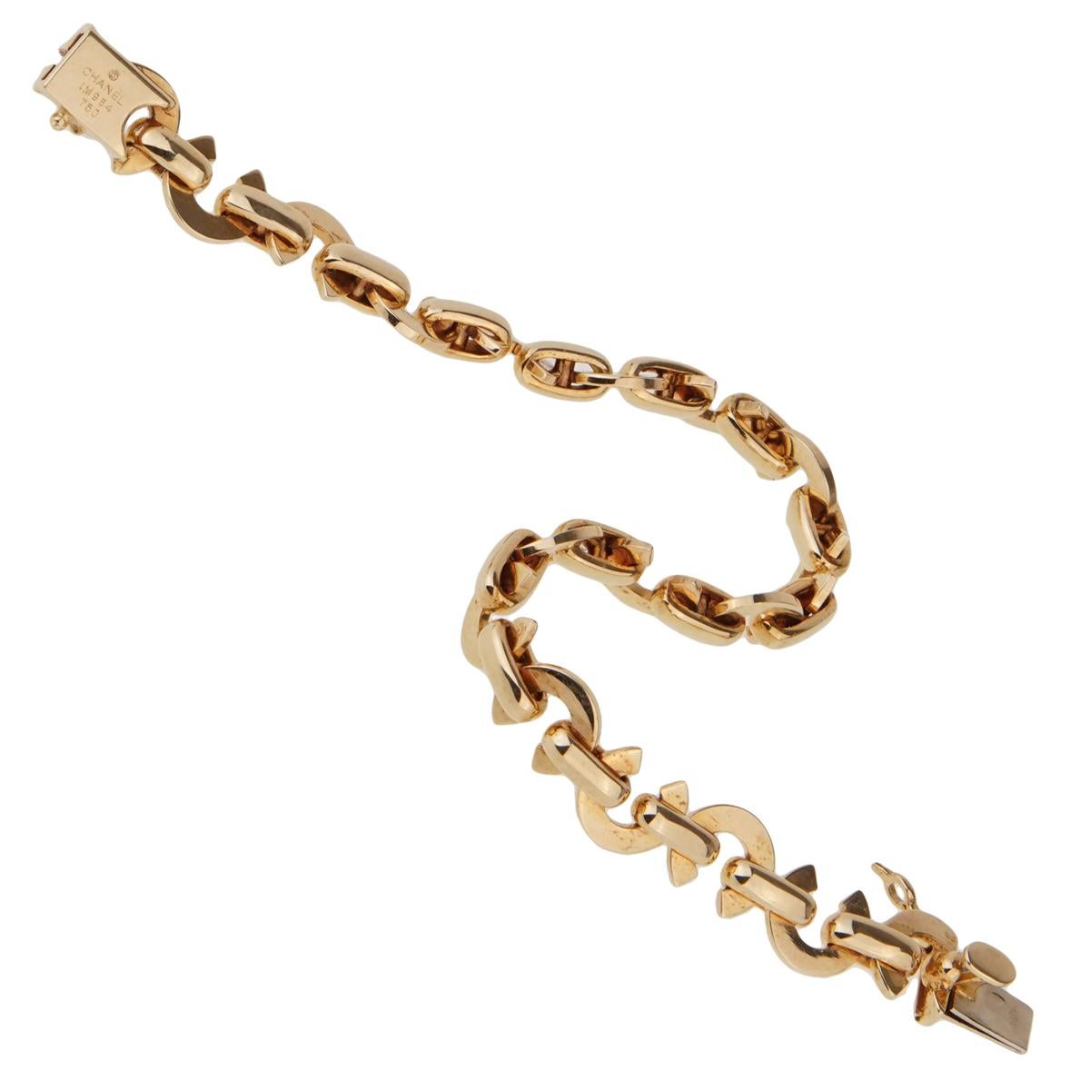 An iconic Chanel charm bracelet featuring alternating Chanel C motifs in 18k yellow gold. The bracelet measures 6 1/4