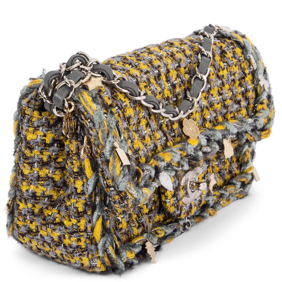 100% authentic Chanel 2017 Charms Tweed Small Flap shoulder bag in chartreuse, grey and black tweed fabric with a braided trim that is embellished with beige-gold and silver-tone charms. The bag features a silver-tone CC turn-lock and chain shoulder