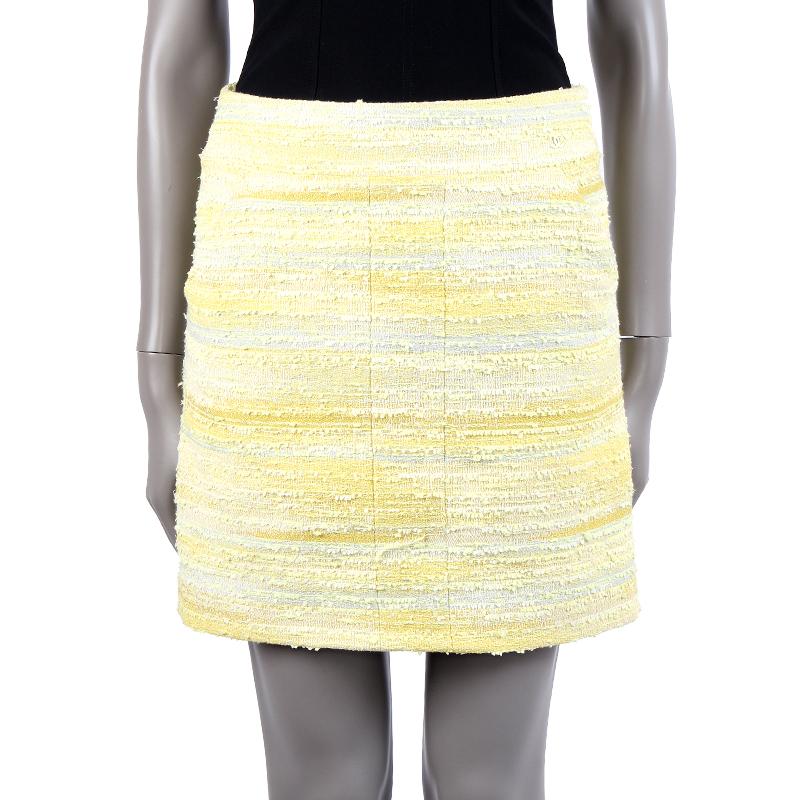 100% authentic Chanel boucle short skirt in gradient yellow, lime, light grey, and off-white nylon (46%), cotton (21%), polyester (17%), rayon (11%), and acrylic (5%). With two slit pockets. Closes with invisible back zipper and one hook-and-eye