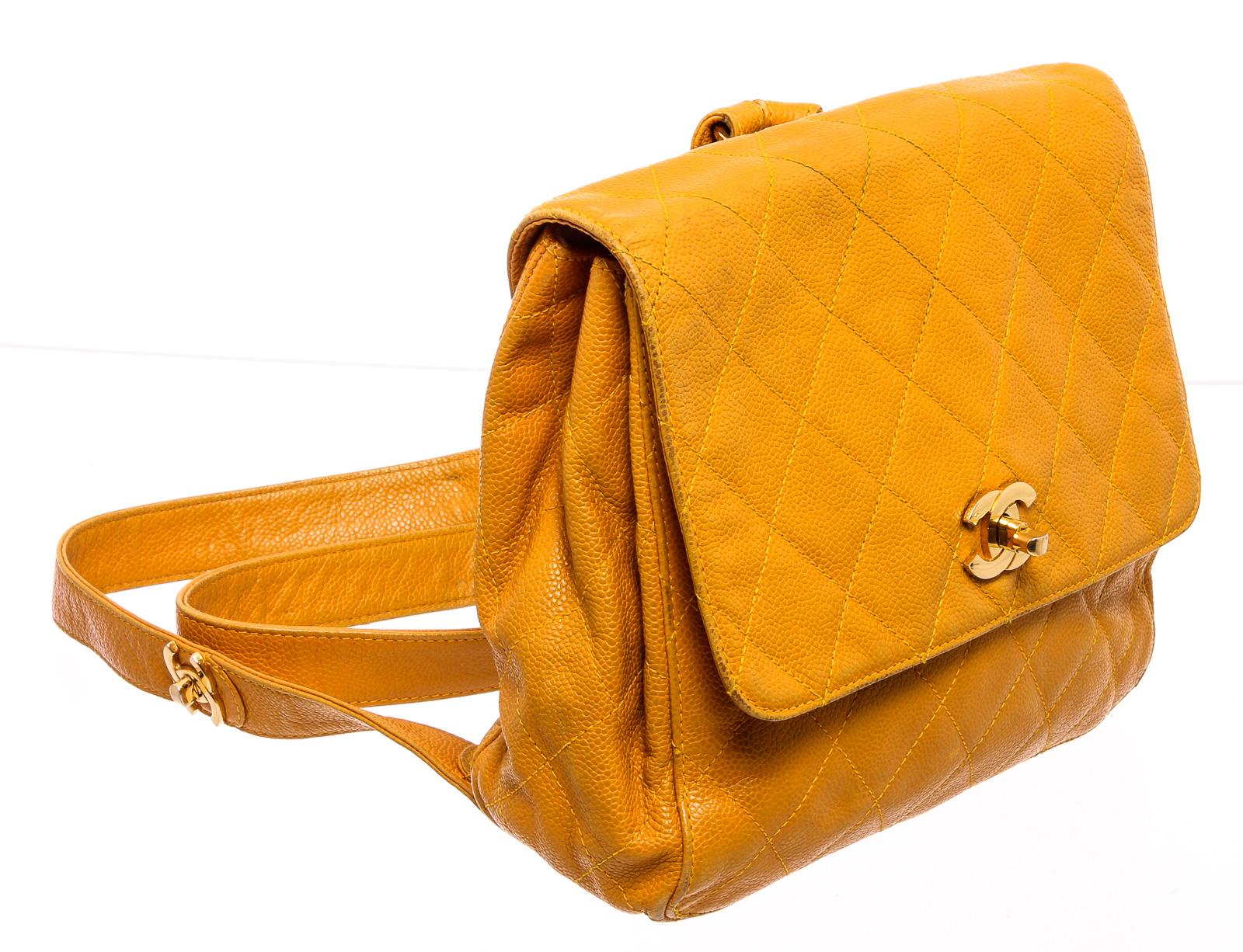 Yellow quilted caviar leather Chanel vintage backpack with gold-tone hardware, dual leather shoulder strap, single slip exterior pocket, cream fabric lining and turn lock CC flap at front.

22289MSC 
