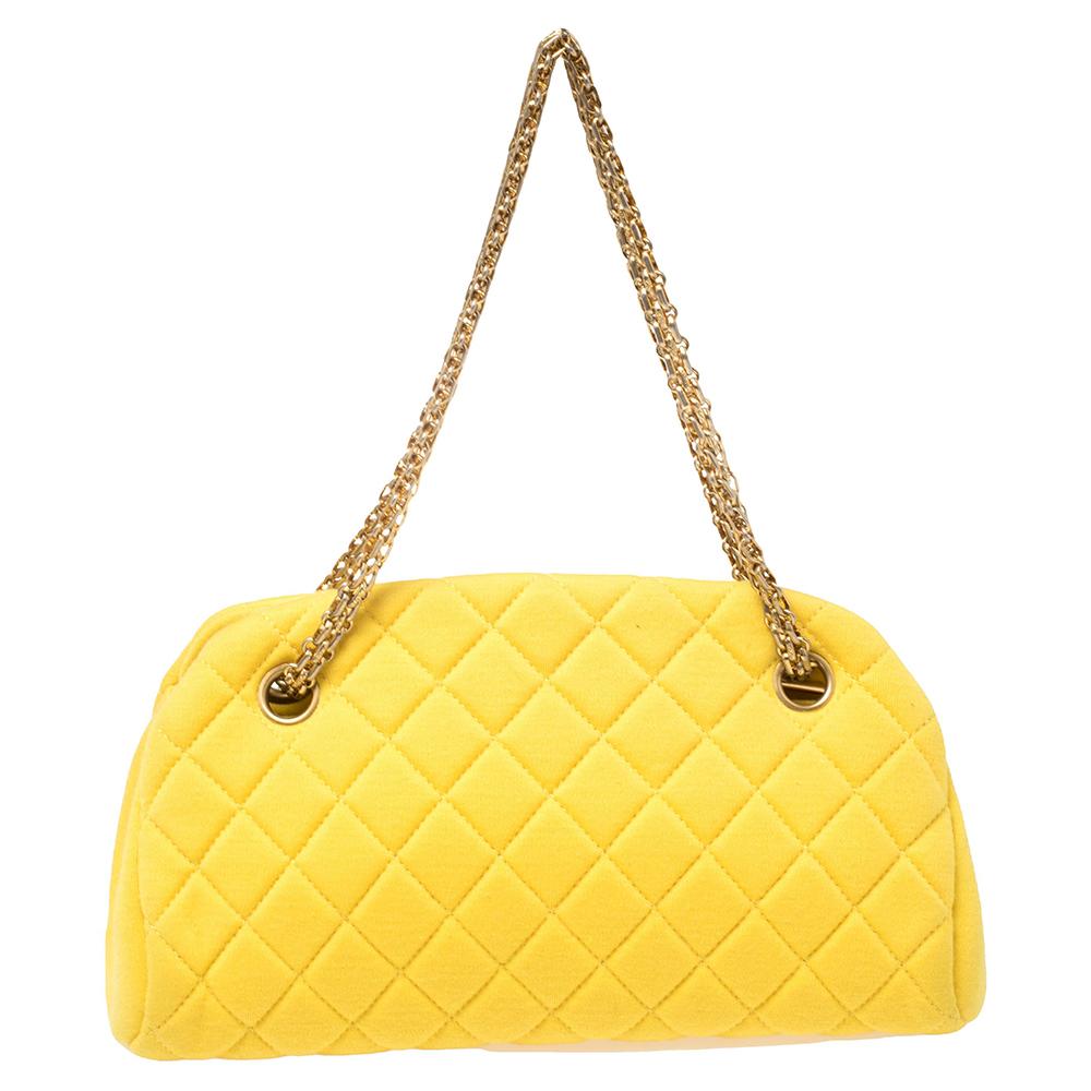 The Just Mademoiselle is another loved bag from Chanel. Crafted from quilted jersey fabric, this beauty in bright yellow is lined with leather and held by chain handles. This bag has well-sized compartments for your necessities and a CC charm for