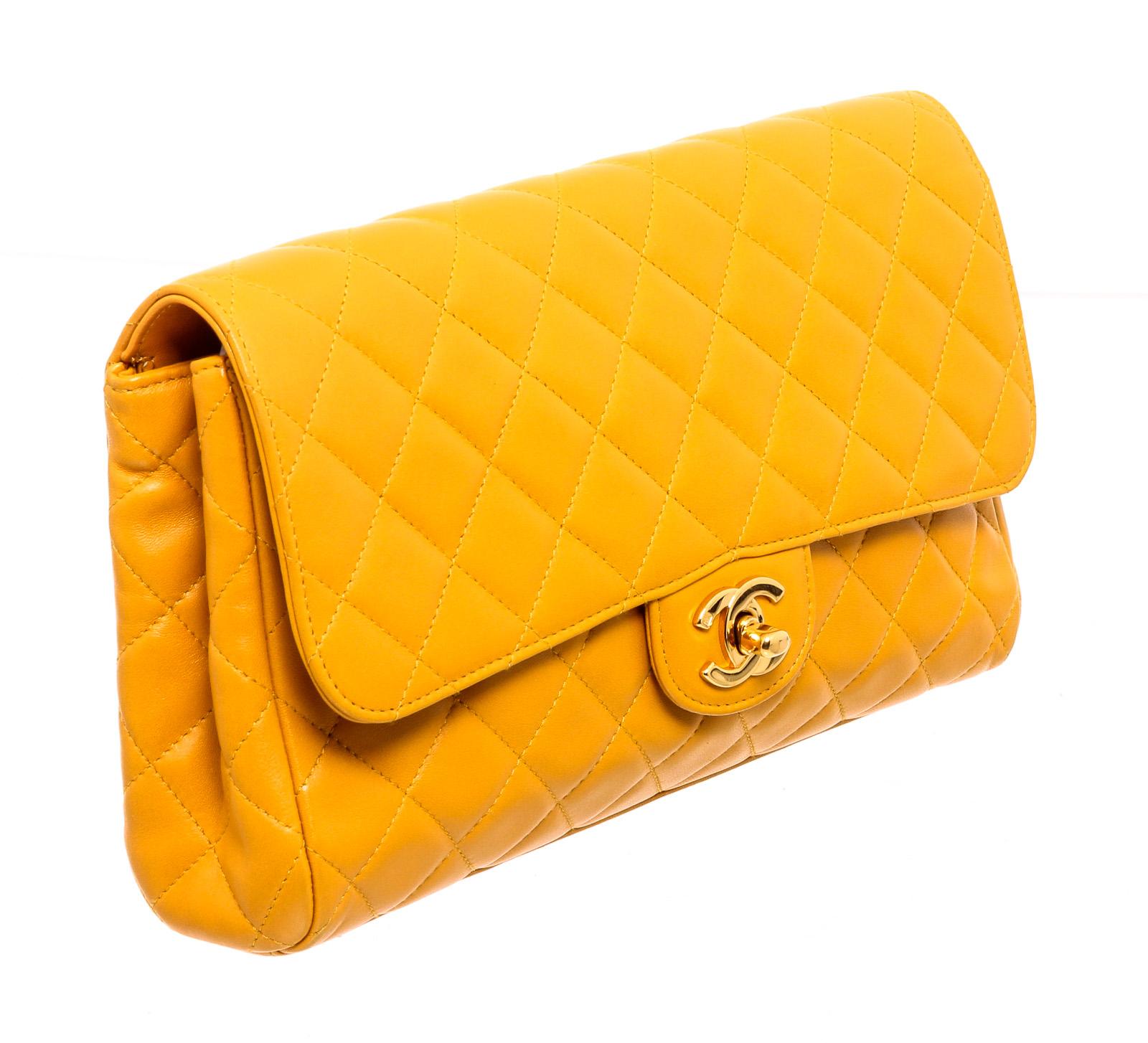 Chanel yellow quilted leather Flap Clutch bag with gold-tone hardware, tonal leather lining, rear exterior slip pocket, interior zip pocket, interior slip pocket, and CC turn-lock closure.

24149MSC