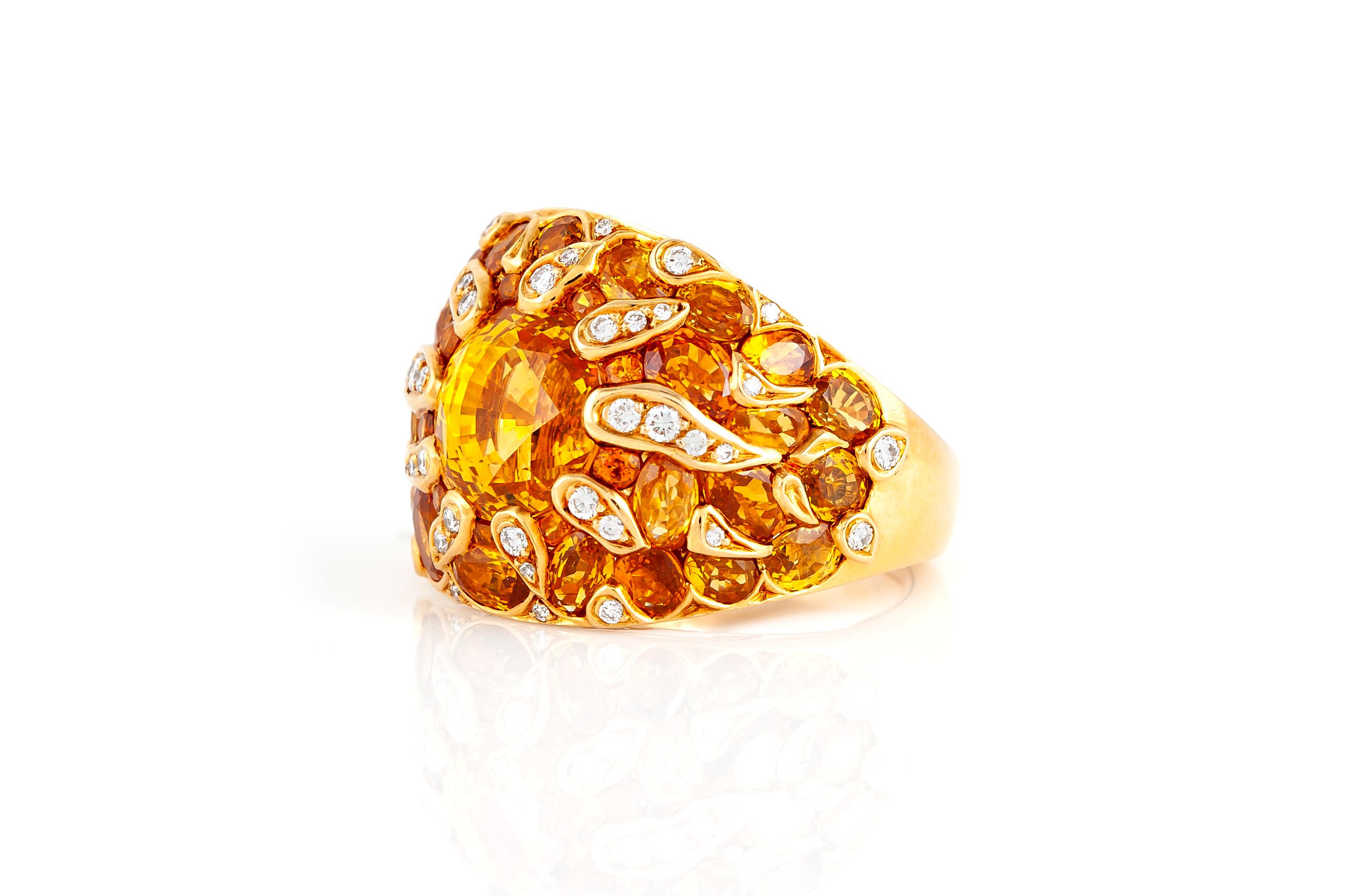Chic and sunny ring created by Chanel. Features an orange sapphire in the center accentuated with yellow sapphires and diamonds set in 18K yellow gold.