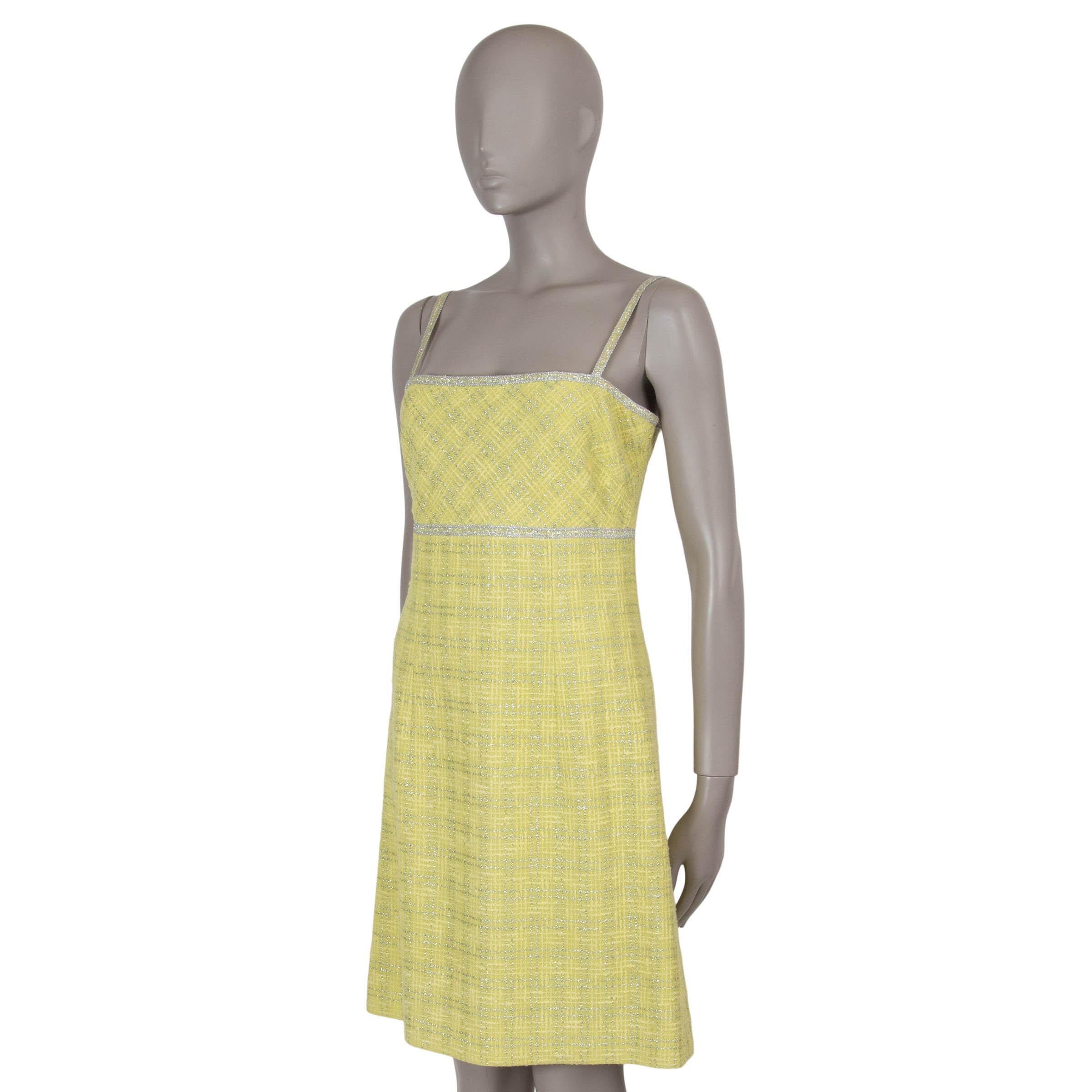 This 100% authentic Chanel sleeveless dress in chartreuse is crafted from a luxurious blend of wool (45%), cotton (38%), metal (15%), and polyamide (2%). Accented with a metallic silver windowpane pattern and trim, it features a sophisticated square