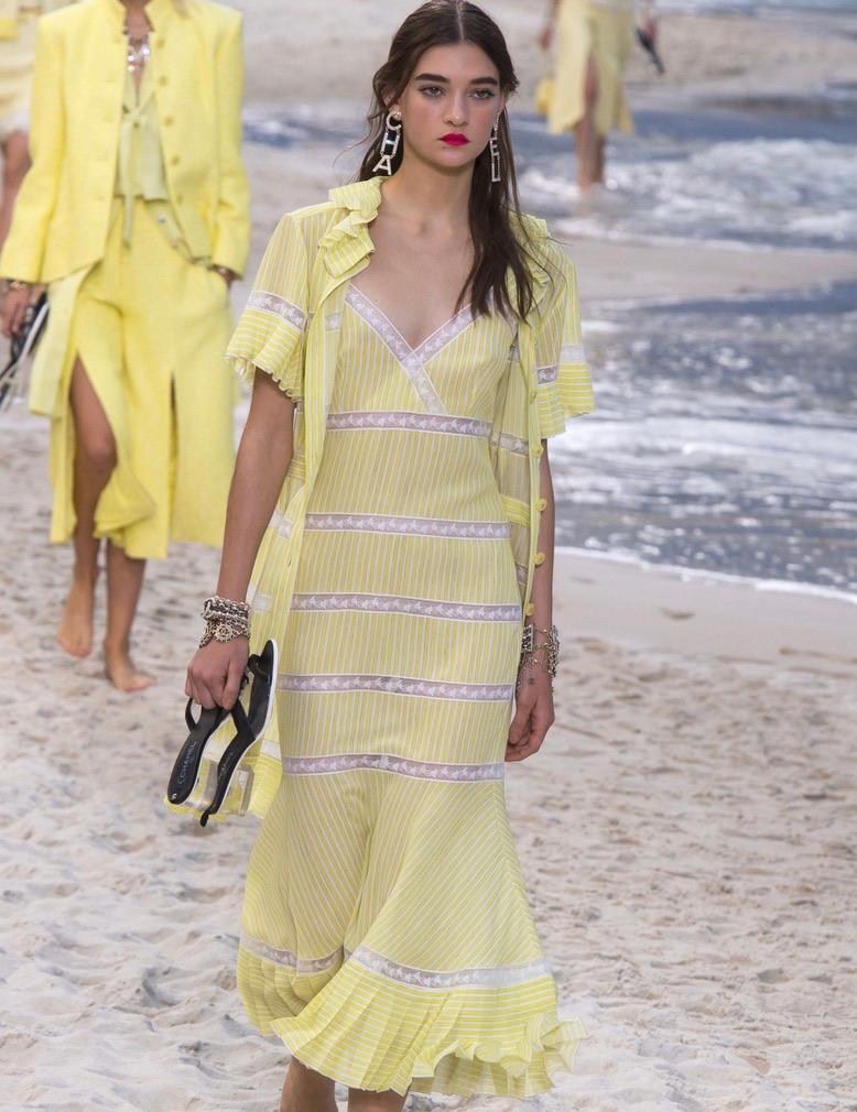 Wow Spring is calling! This classic yellow Chanel striped sun dress is a real show stopper. Featuring yellow and white stripes, lace detailing, a Chanel logo button and a pleated hem, this dress is perfect for any occasion from Sunday brunch to a