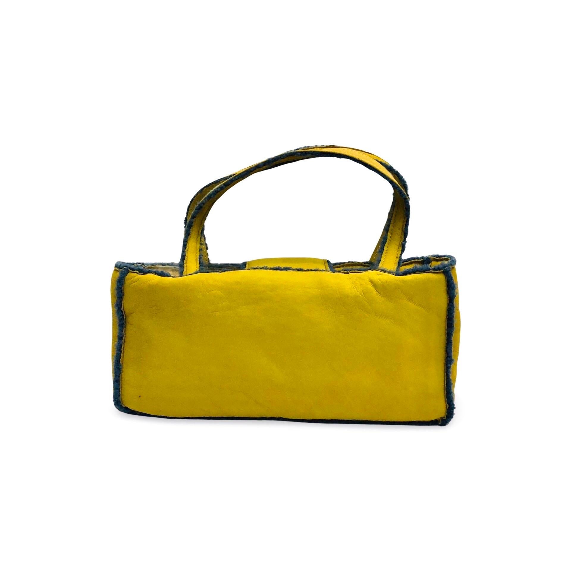 - Chanel yellow suede shearling shoulder handbag from 1998 collection. 

- Featuring blue shearling mouton trim overall. 

- CC turn-lock flap closure. 

- Interior zip pocket. 

- Length: 32cm. Height: 16cm. Width: 7.5cm. Handle Drop: 18cm