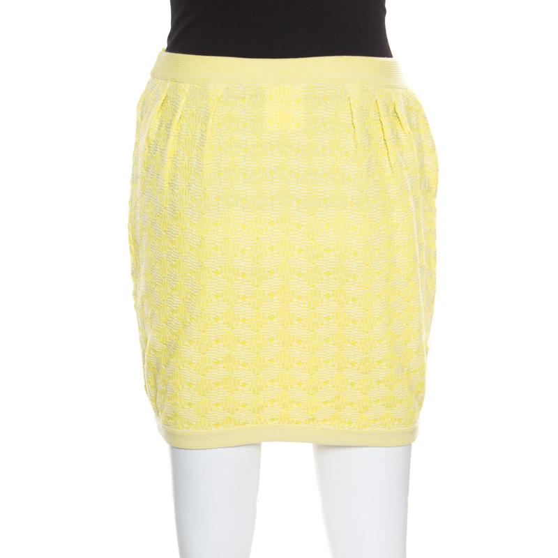 Chanel's expertise in designing clothing that is wearable and comfortable without compromising on style includes this yellow mini skirt. It is made from cotton and covered in jacquard detailing all over. The skirt can be paired with white boots and