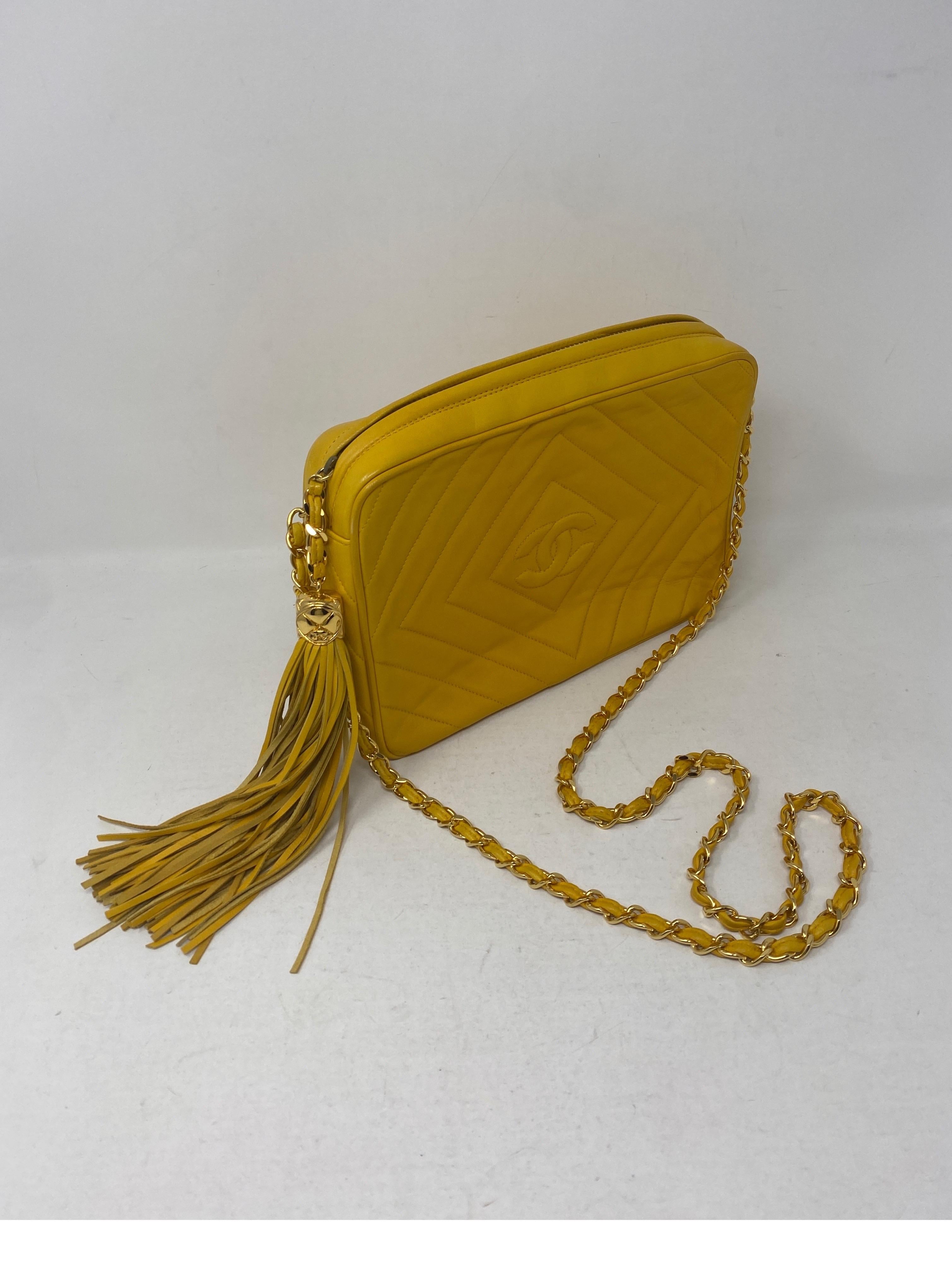 Chanel Yellow Vintage Bag. Tassel Camera Bag. Gold hardware. Bright yellow color. Lambskin leather. Can be worn crossbody. Excellent condition. Includes authenticity card. Guaranteed authentic. 