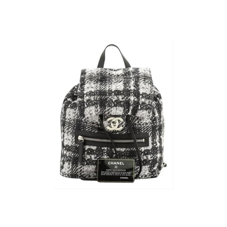  Chanel Zip Backpack Printed Nylon Medium

Black and white printed nylon, features leather top handle, woven-in leather chain link straps, front flap with CC turn-lock closure, exterior front zip pocket, and silver-tone hardware. Its flap and
