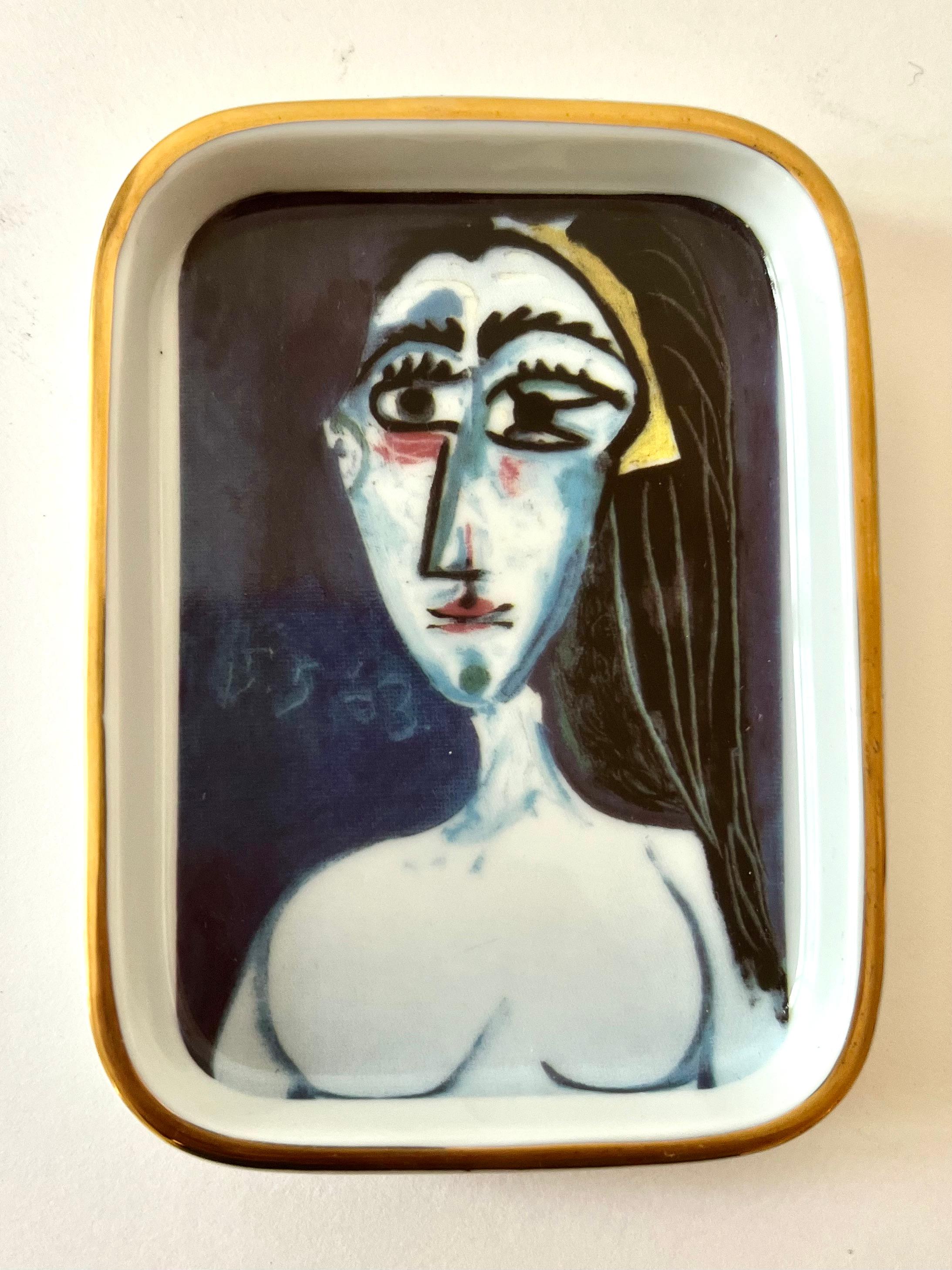 A ceramic or porcelain dish with a gilt edging and image of Picasso's 1963 Portrait, 