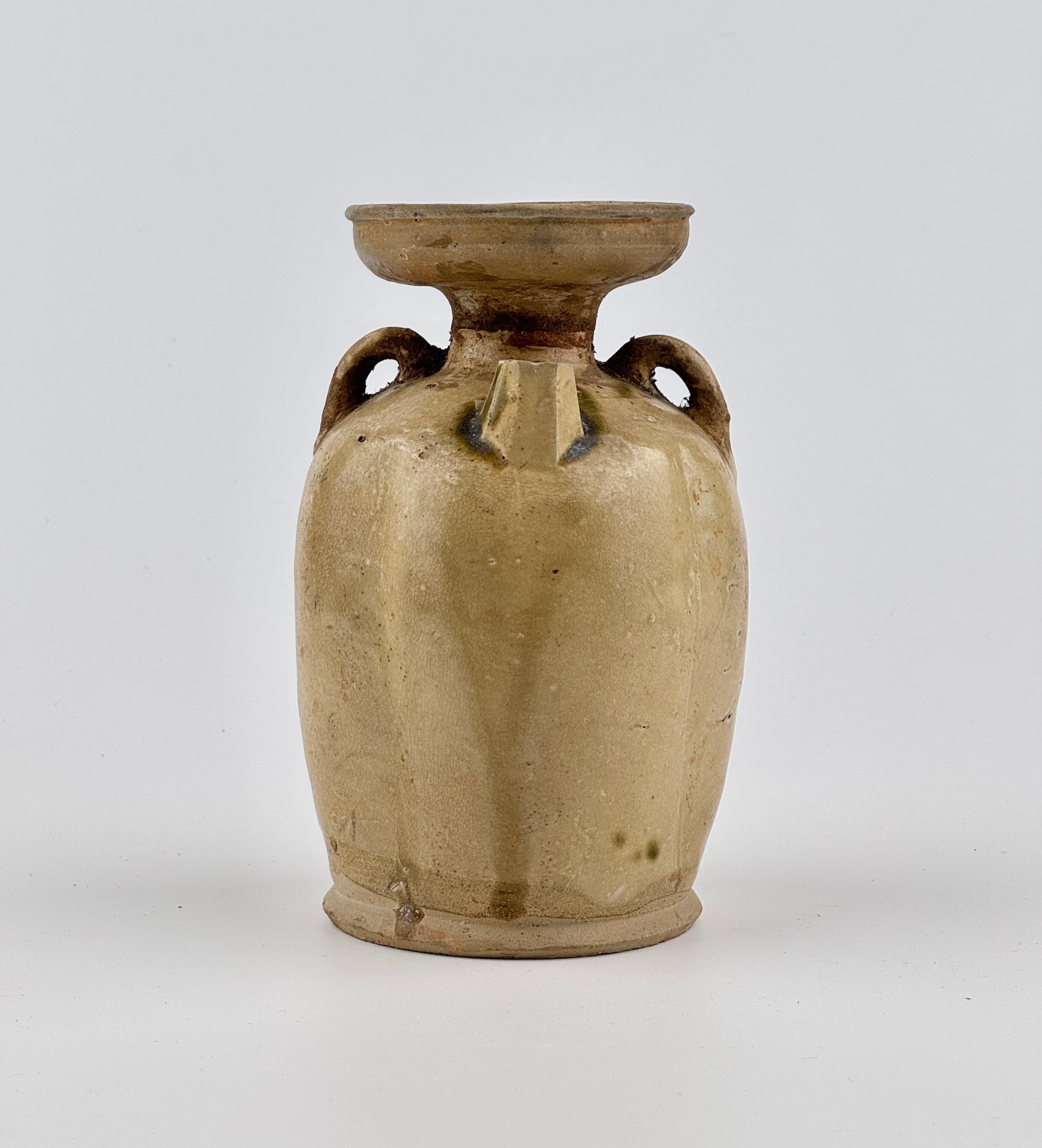 It features two small lug handles on either side of the neck and a spout opposite the main handle. This ewer might have been used for wine or other liquids, which were poured through the spout for drinking or ceremonial purposes.

Date : 9th