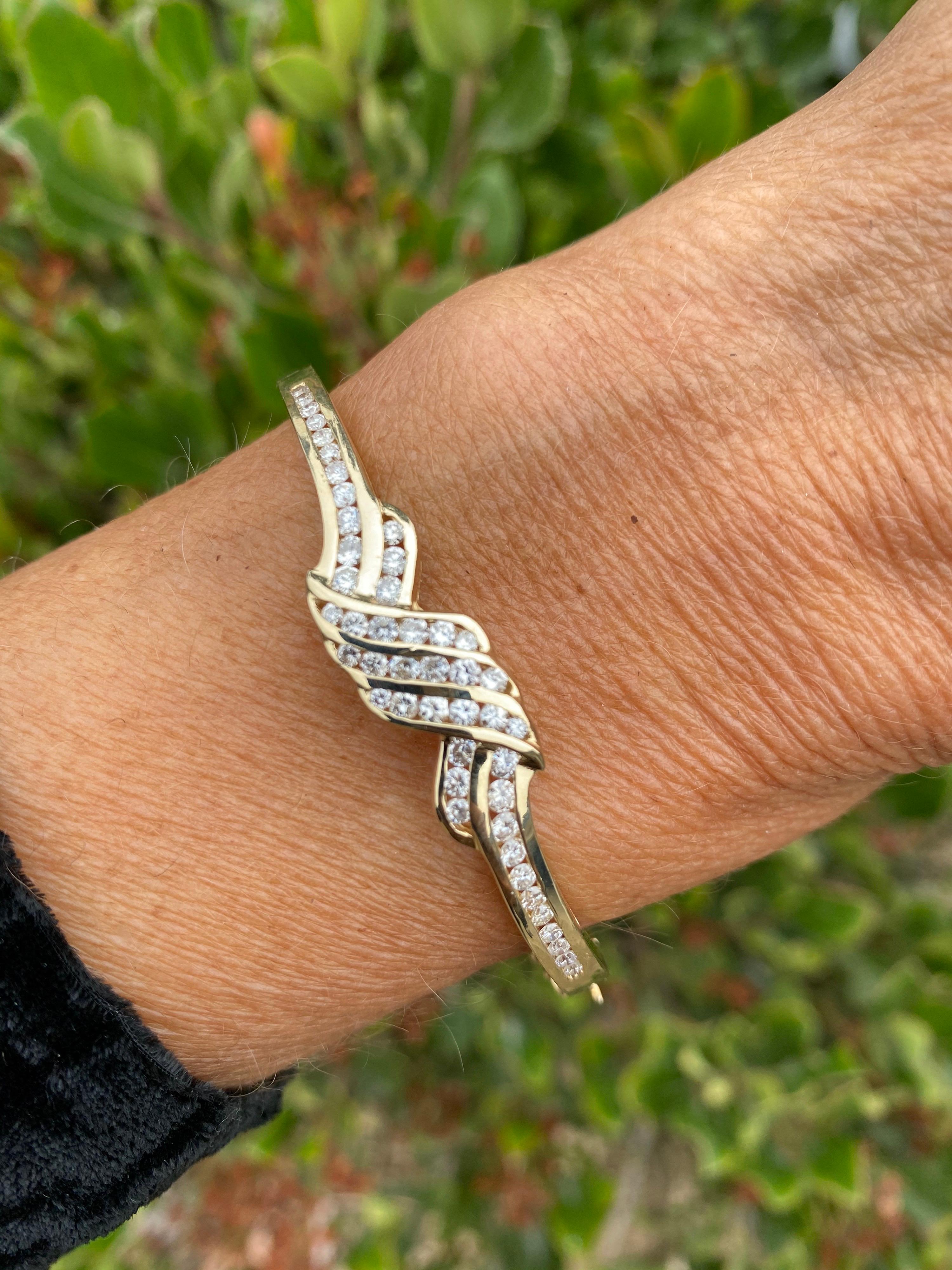 Channel Diamond Bracelet

14 karat yellow gold measuring 10.74 mm wide.
The berth width of the diamonds are 55.40 mm and compasses the top portion of the bracelet.
The height is 5.07 mm tall with plenty of support
Substantial gold weight is 17.6
