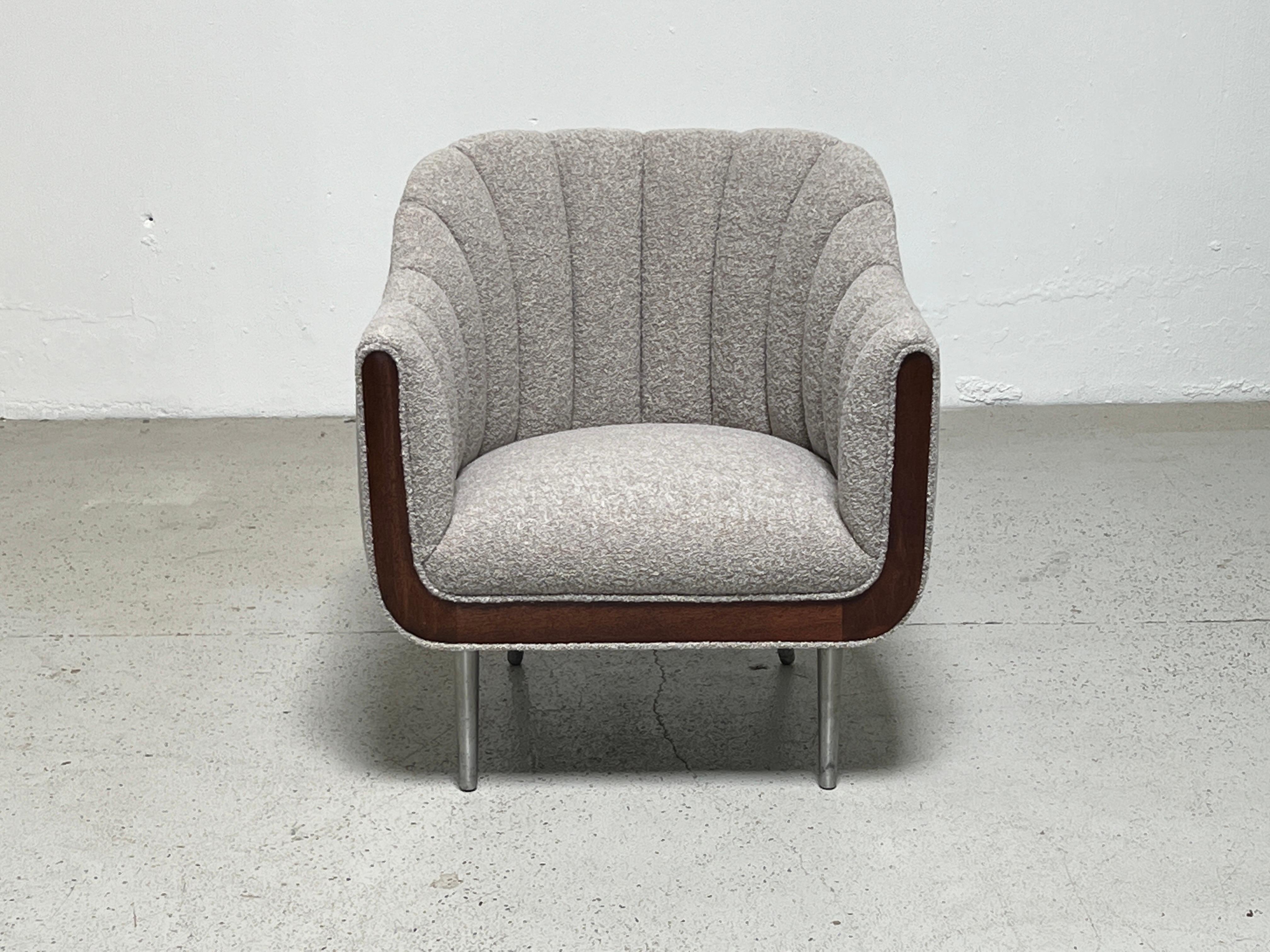 An unusual and early design by Edward Wormley for Dunbar. This channel back lounge chair has mahogany trim and aluminum legs. Fully restored and reupholstered in Designtex / Lambert / Smoke.