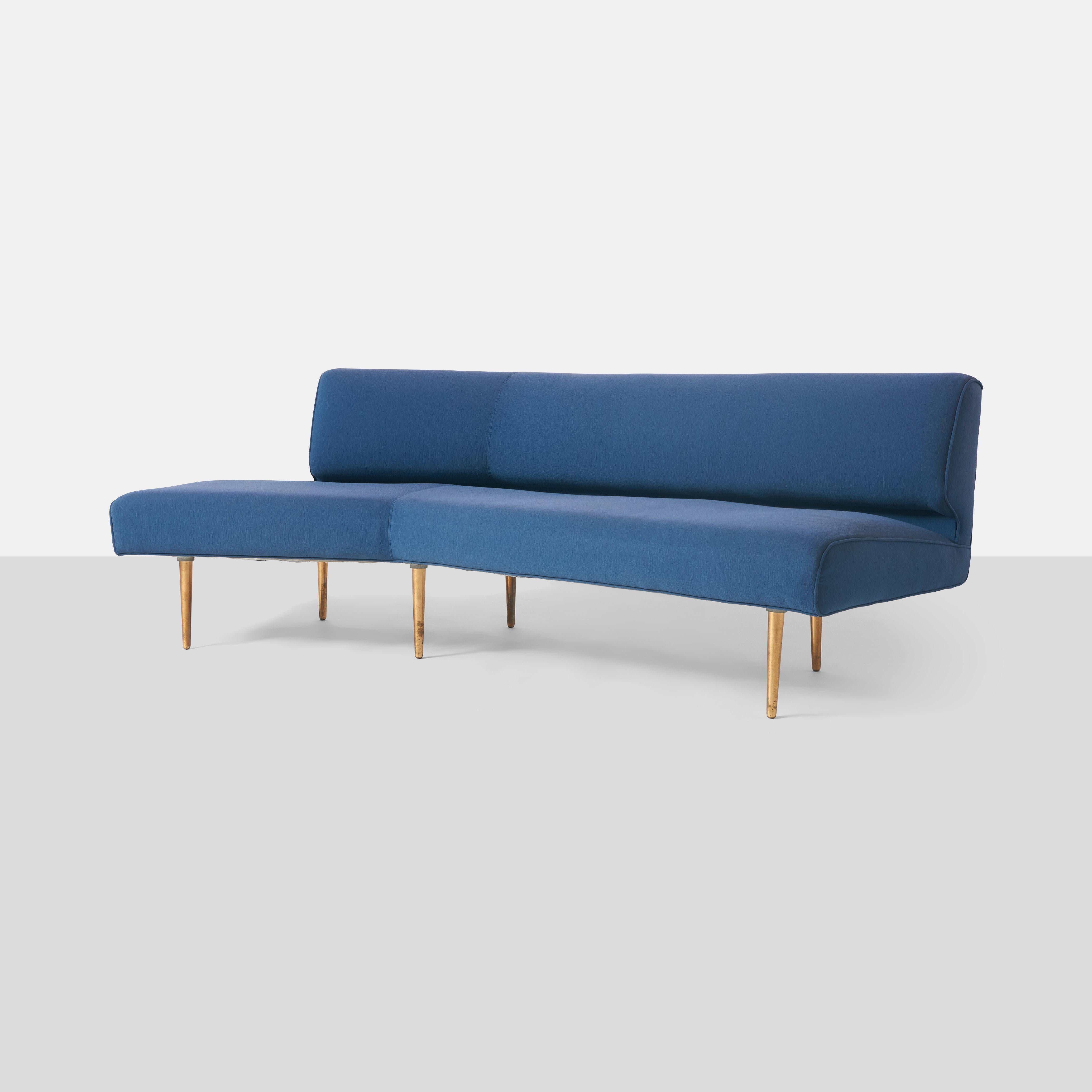 An early channel back sofa with brass legs and covered in blue fabric by Edward Wormley. Model #4757 designed in 1947. The fabric is tired and should be replaced.

Price shown without restoration.