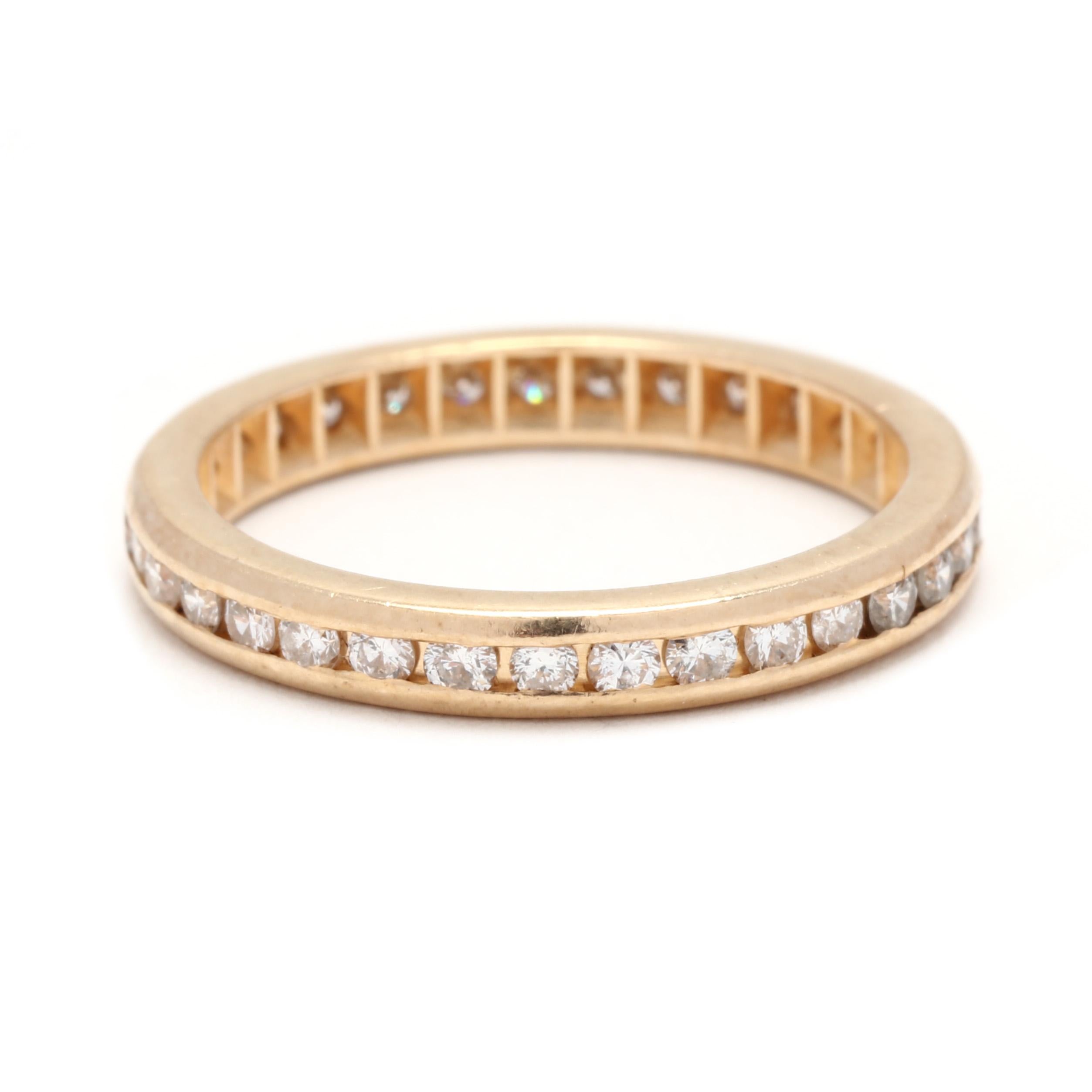 A vintage 14 karat yellow gold channel diamond eternity wedding band. This stackable eternity band features a thin eternity design with channel set round brilliant cut diamonds weighing approximately .50 total carats.

Stones:
- diamonds, 32